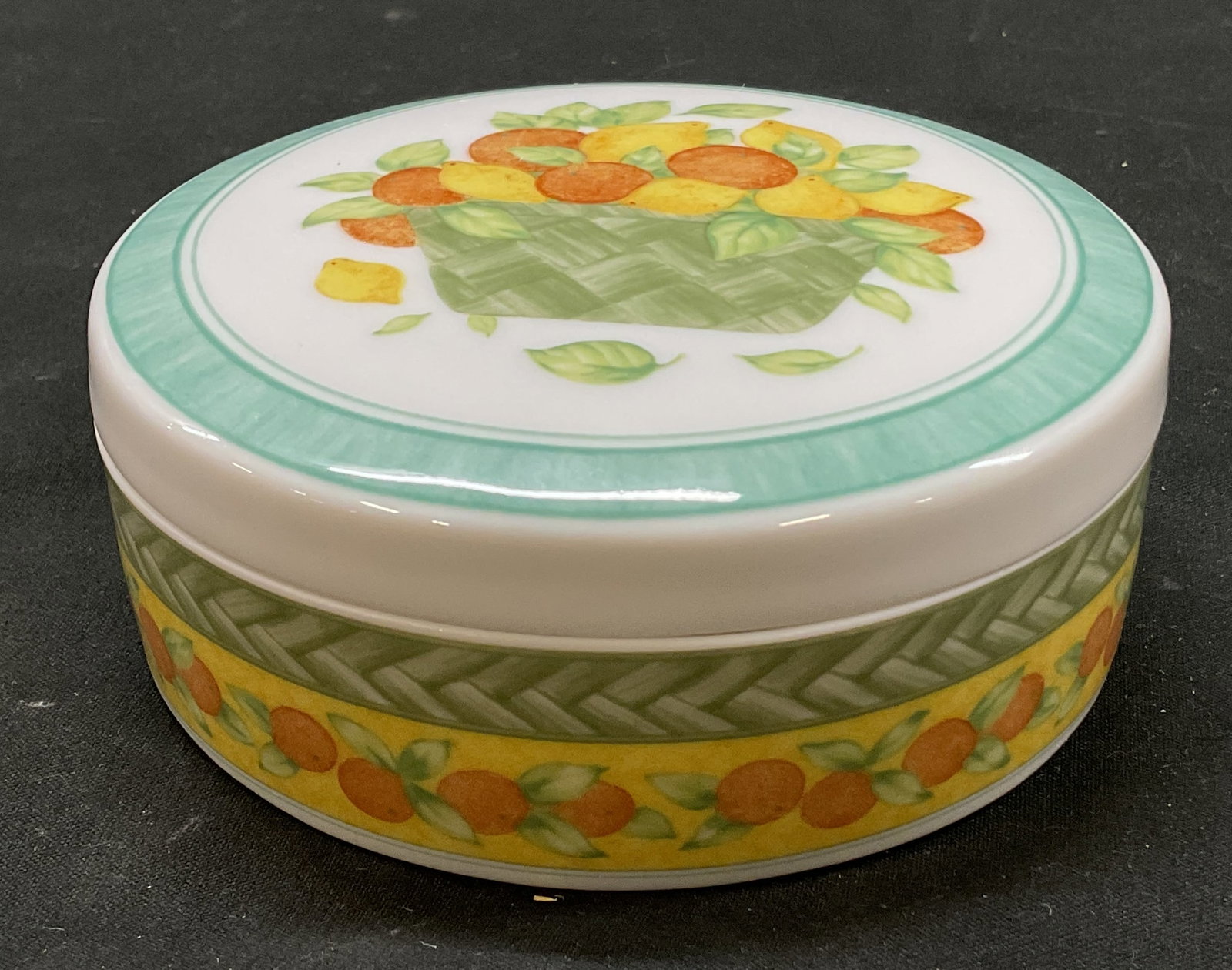 Vtg Vista Alegre Lidded Porcelain Trinket Box, POR: Vintage Vista Alegre Vila Franca Lidded Porcelain Trinket Box. Made in Portugal. White porcelain with high gloss glaze finish. Lid decoration- illustration of woven basket with citrus and leaves.