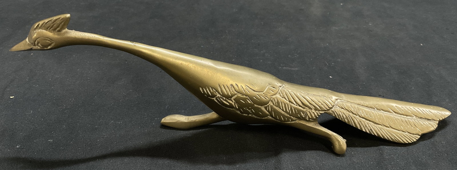 MID-CENTURY MODERN Brass Roadrunner Figurine: Mid-Century Modern Brass Roadrunner Figurine. Detailed Etched Feathers. Hollywood-Regency Style. Oxidization Present. Measures app 2.75in H x 9in L. Mid-Century Modern, Vintage Figurines, Brass,