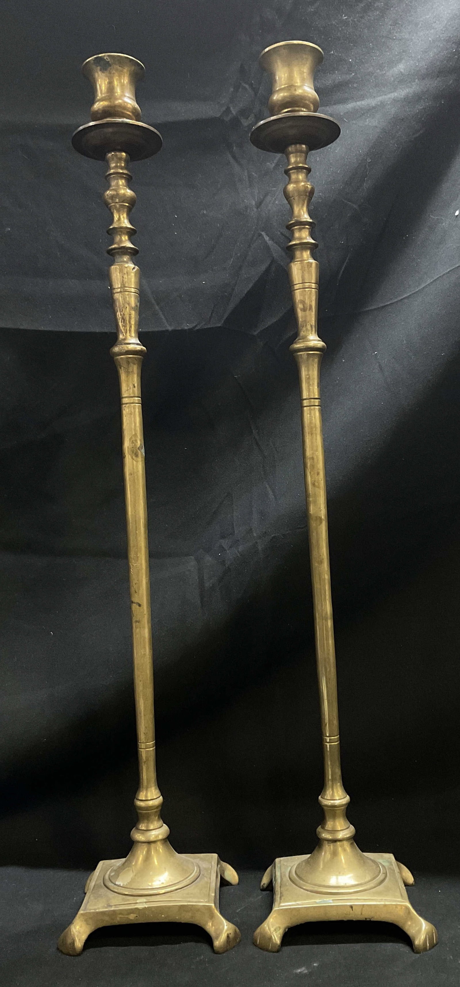 VTG Solid Brass 20.25in Tall Candlestick Holders: Vintage Art Deco Style Solid Brass Candlestick Holders. Tall, Slender Taper Design. Square Paw Footed Base. Scratching and Oxidization Present. Measures app 20.25in H x 4in W. Vintage Candlestick
