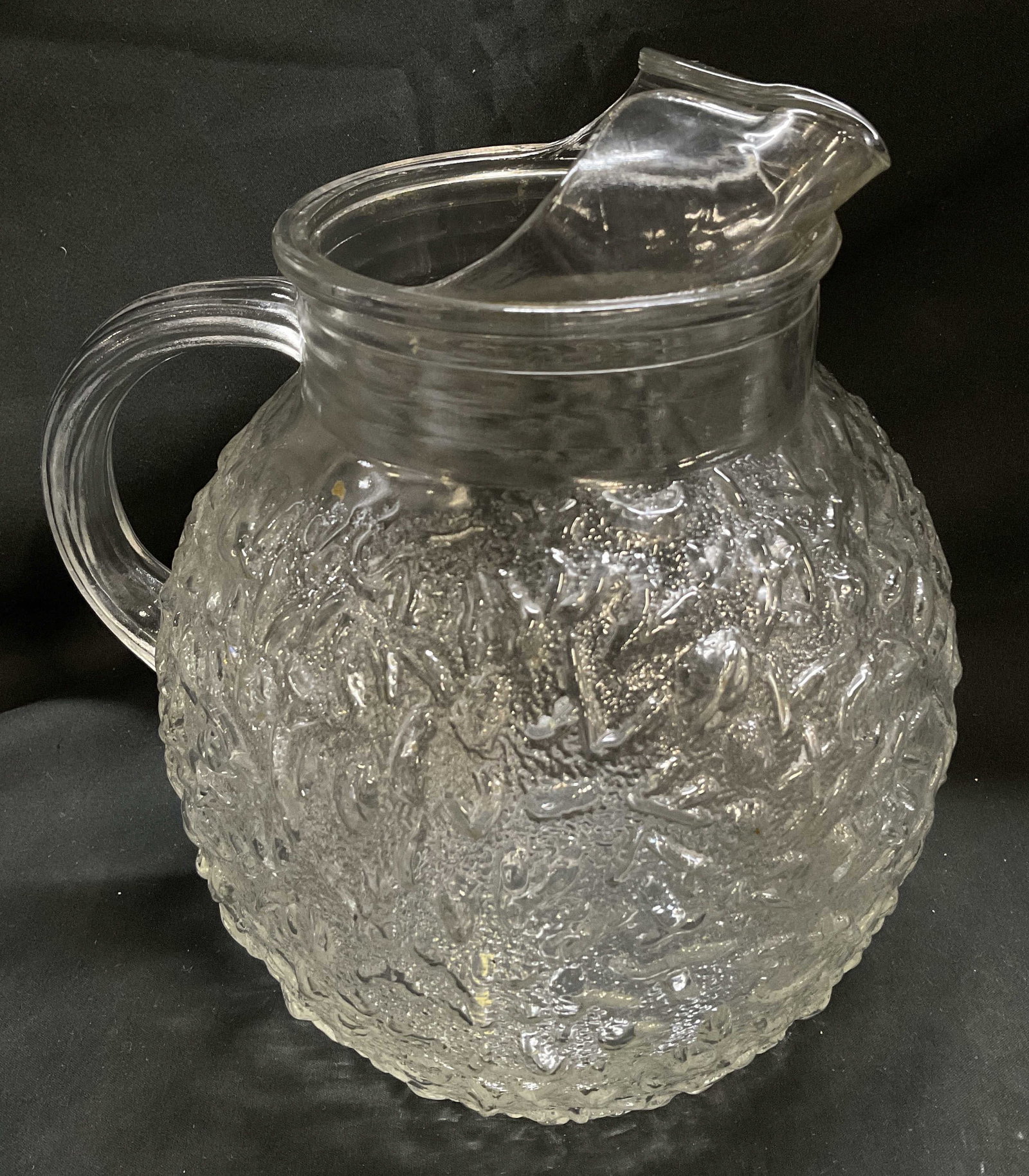MCM Clear Crinkle Art Glass Pitcher: Mid-Century Modern Clear Crinkle Art Glass Pitcher. Round Ball Shape. Ice-Catcher Spout. Scratching Present. Measures app 9.5in H x 8in Diam. Mid-Century Modern, Vintage Pitcher, Crinkle, Art Glass,