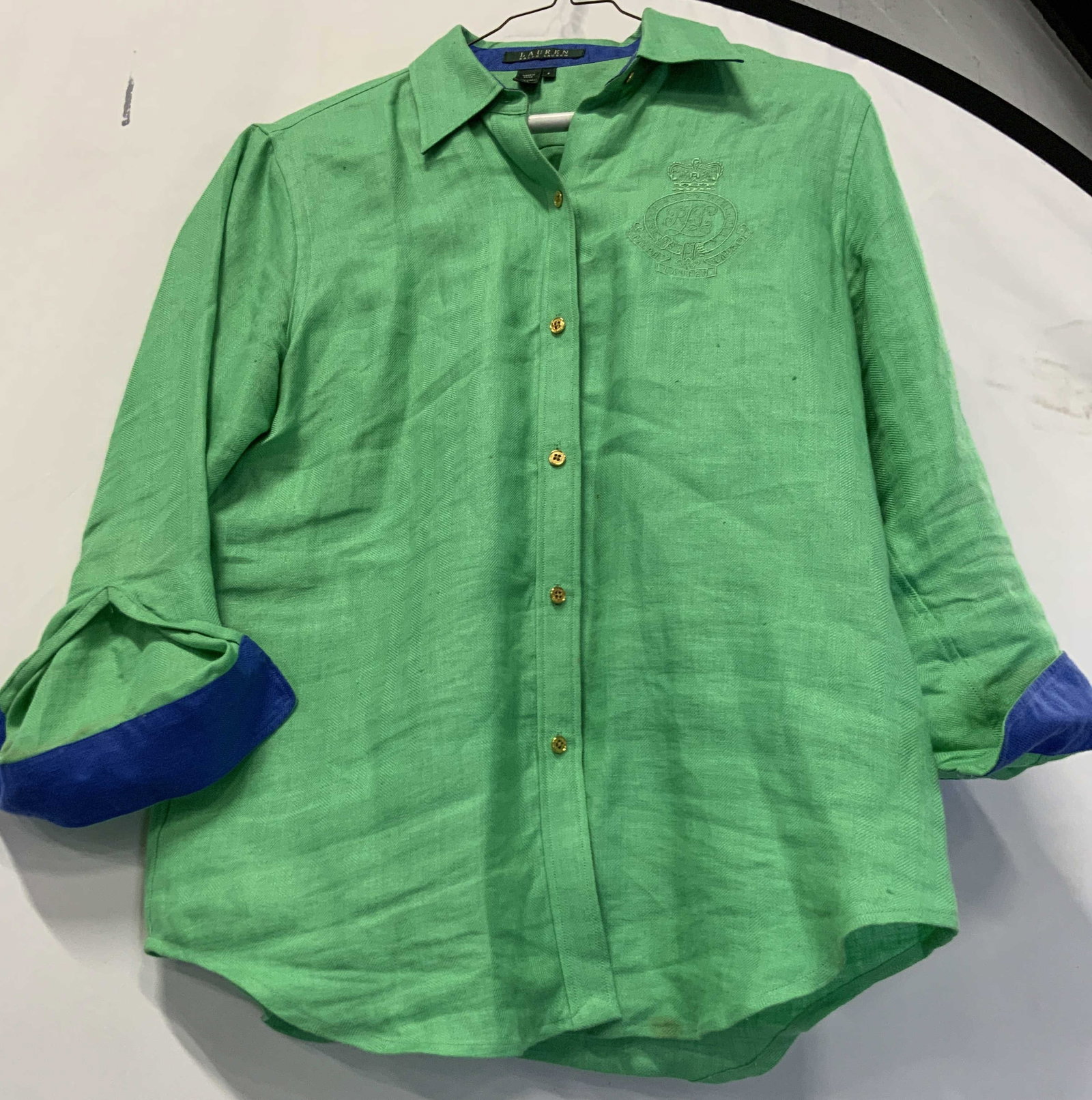 Ralph Lauren linen green button down: Ralph Lauren linen green button down. 100% linen in size small. 3/4 sleeves with blue lined cuffs for rolling. Shirt is green with gold buttons and embossed Ralph Lauren logo on the left chest.