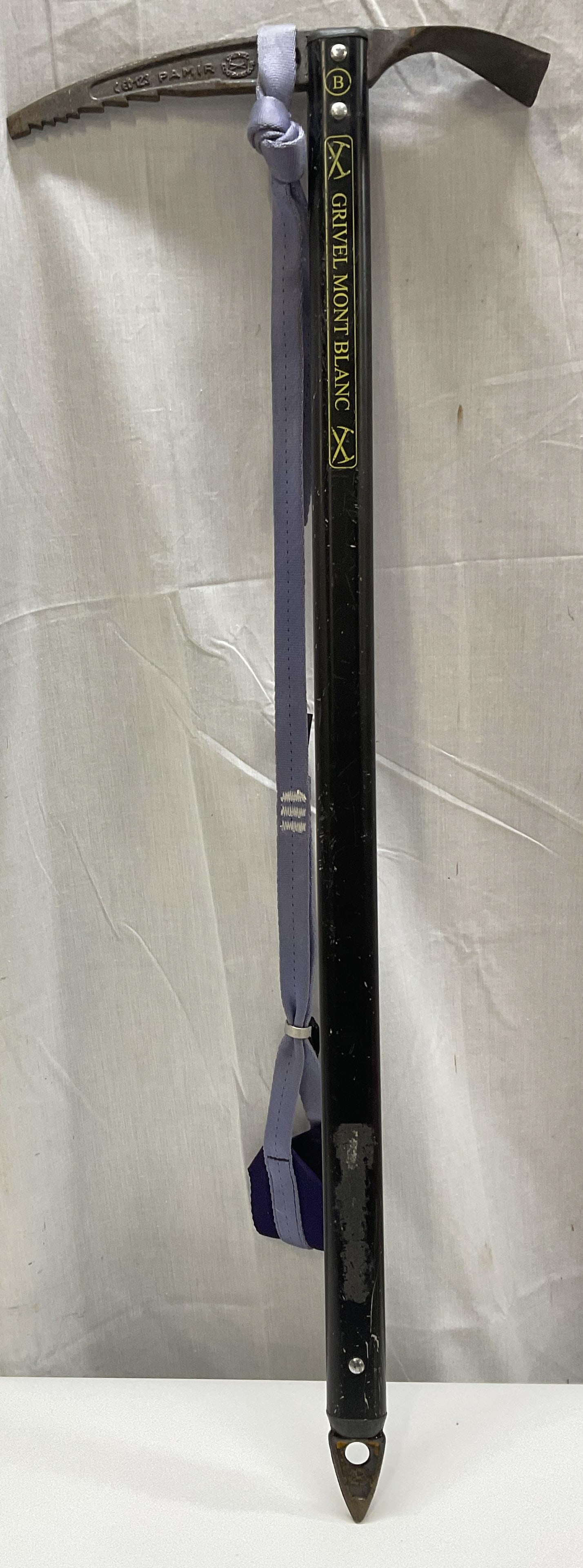 VTG Grivel Mont Blanc Ice Axe ITALY: Vintage Circa 1990s-2000s Grivel Mont Blanc Ice Axe. Pamir Model. Built as Trekking Axe for Glacier Walking. Black Metal Shaft with Steel Blade. Purple Wrist Leash. Rusting to Blade and Scratching on