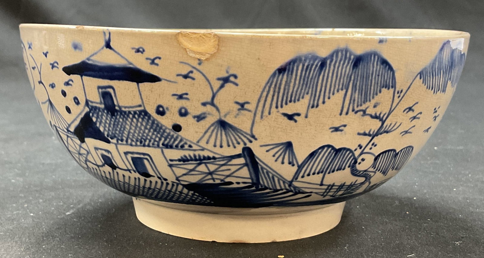 Vintage Pearlware Pottery Hand Painted Blue Bowl: Vintage pearlware pottery hand painted blue bowl. No visible markings. Delft style design. Short pedestal base. Hand painted bird, architecture, tree, mountains and more motifs in blue. Geometric