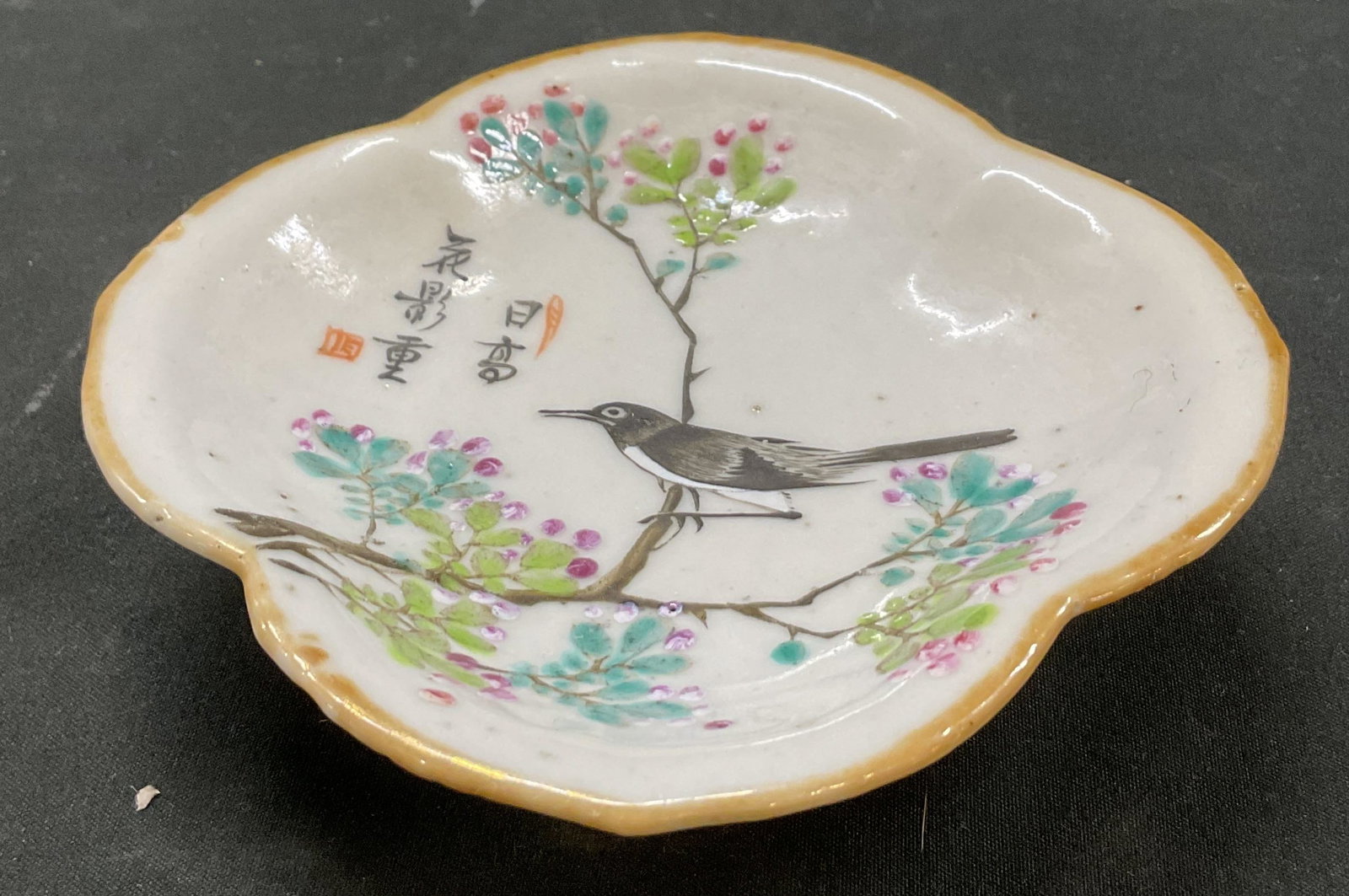 Antique Chinese Porcelain Footed Trinket Dish: Antique Chinese porcelain footed trinket dish. Signed with Asian characters. Scalloped edge. Short pedestal base. Hand painted bird and floral motifs in varying colors. Measures approx 5 x 5 x 1.5