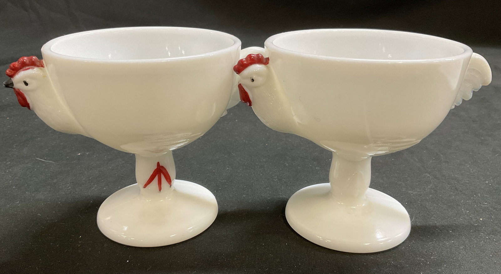 Lt2 VTG Westmoreland Milk Glass Rooster Egg Cups: 2 Vintage Circa 1950s Westmoreland Milk Glass Rooster Pedestal Egg Cups. Hand-Painted Red Accents. Missing Beak on One and Losses to Paint. Measures app 3.5in H x 5in Diam. Vintage Egg Cups, 1950s,