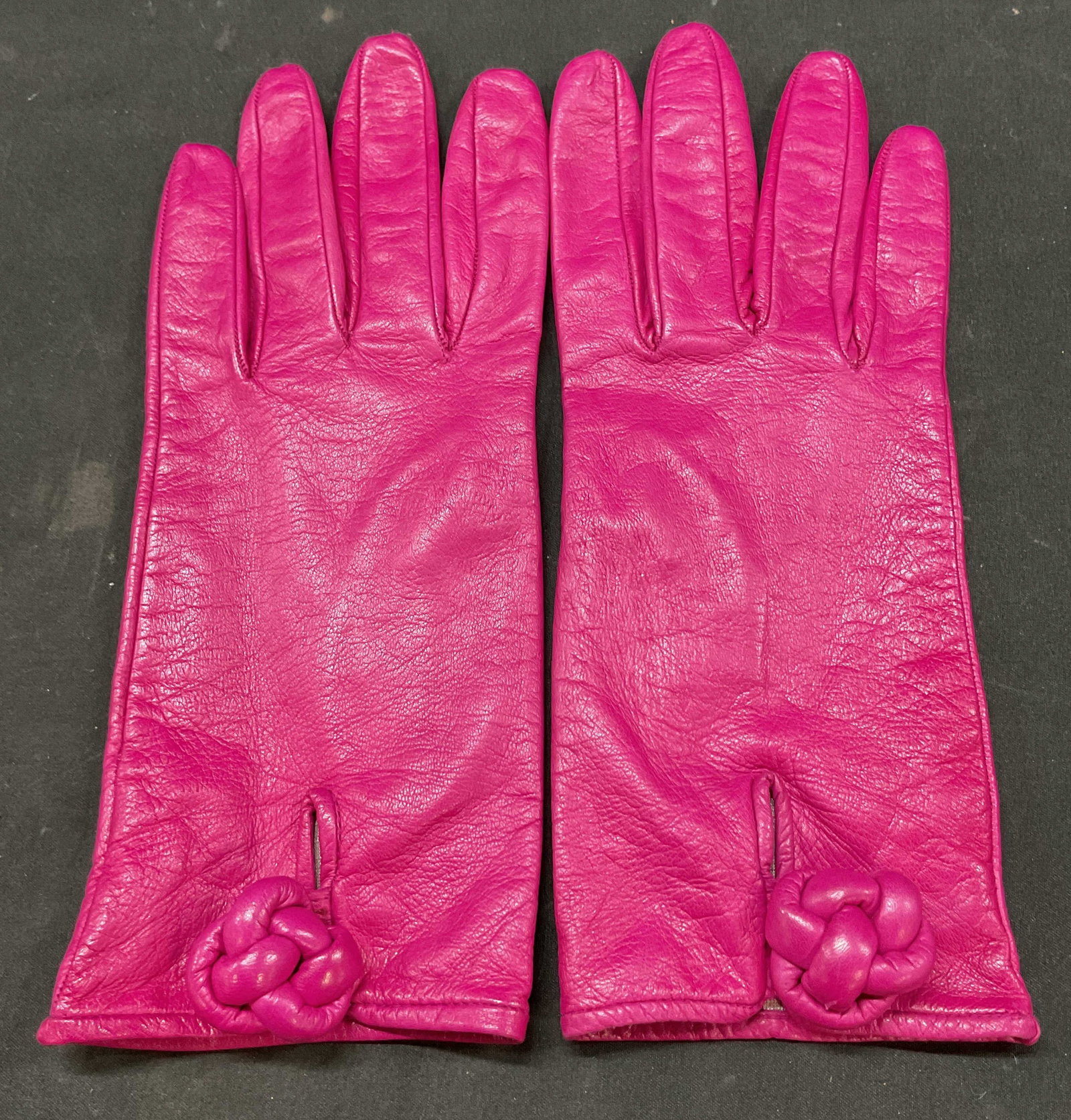 Valentino Garavani Pink Leather Gloves Italy: Valentino Garavani pink leather gloves. Made in Italy. Genuine leather and silk lining. Size 7.5. Decorative button accent. Wear consistent with exposure. Gloves, Valentino Garavani, wearables,