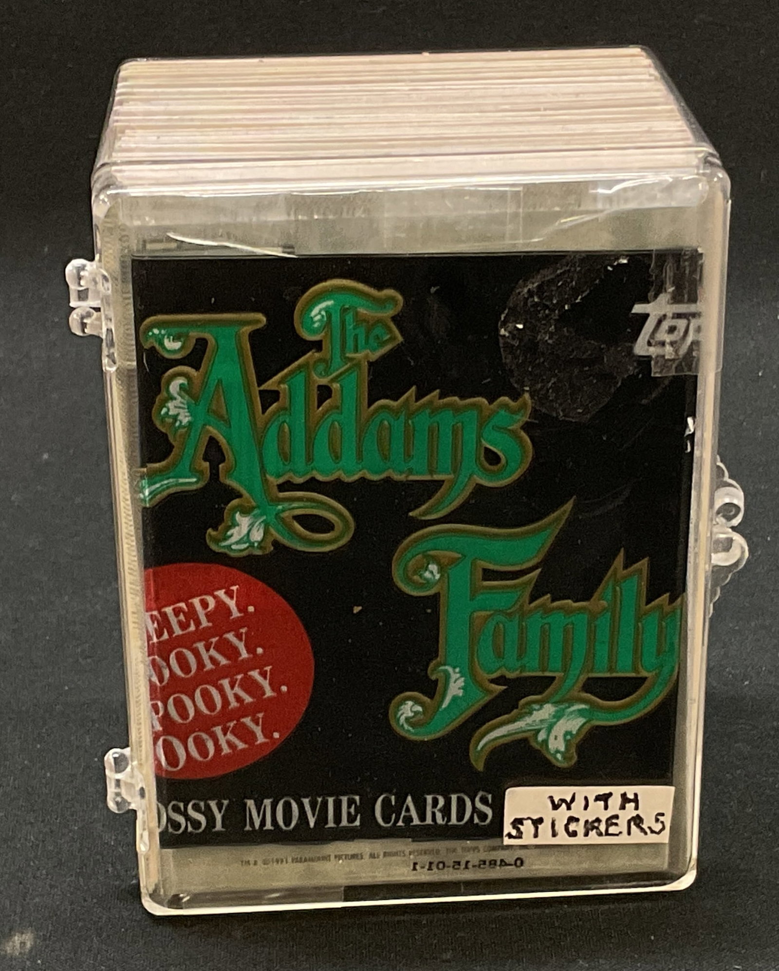 Vtg.1991 Topps Addams Family Movie Cards: Vintage 1991 Topps Addams Family Glossy Movie Cards and Stickers Lot in Plastic Case. Creepy Kooky Spooky Ooky catchphrase on packaging. Not inspected individually. Measures approx. case: 4 x 3.5 x 1.