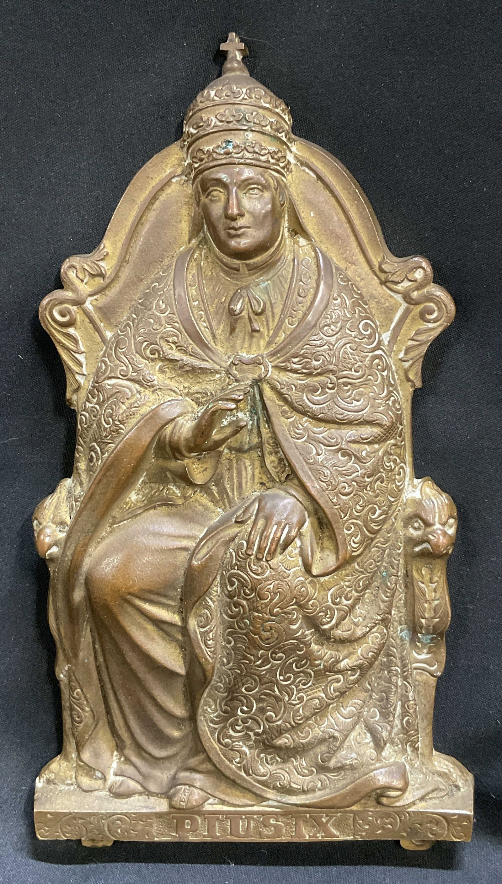 VINTAGE Brass Pope Pius IX Plaque: Vintage Brass Pope Pius IX Plaque. Features Pope Pius IX Sitting on Throne in Intricate Patterned Robes and Papal Tiara Performing Blessing Gesture. Oxidization Present. Measures app 7.5in H x 4in W.