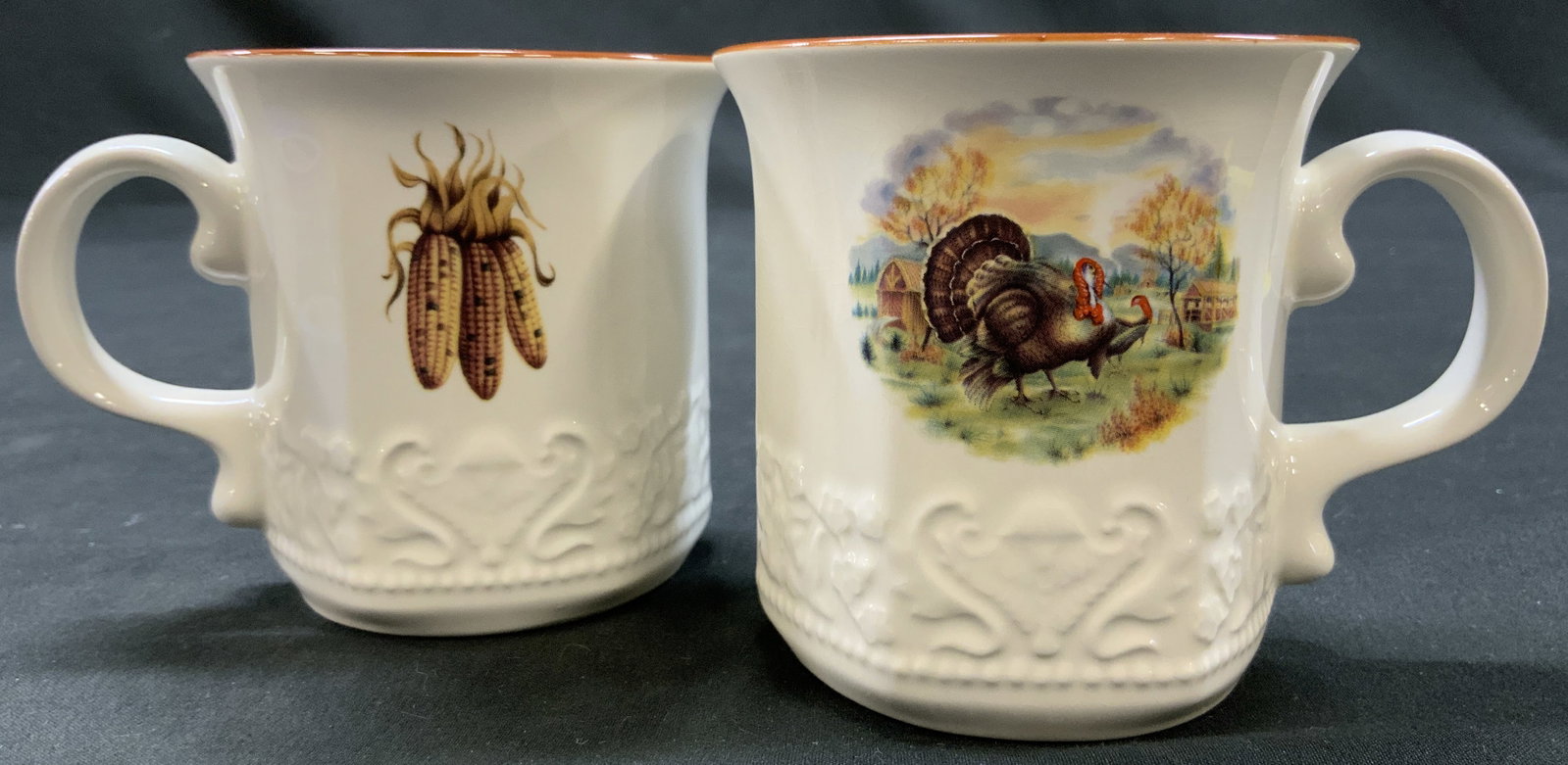 Vtg Lt2 Johnson Bros His Majesty Thanksgiving Mugs: Vintage Johnson Brothers His Majesty Thanksgiving Mugs. Set of 2, Made in England. Warm white base with hand painted red rim. Colorful autumn decals- 1. Wild Turkey in a pastoral field, 2. Trio of col