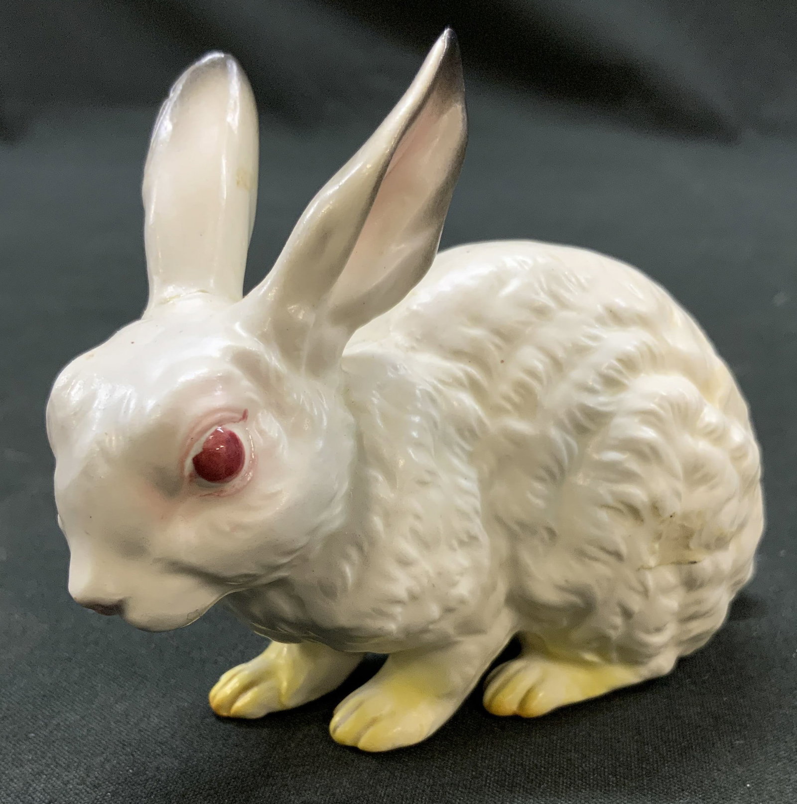Vtg Japan Porcelain Crouching White Rabbit Fig.: Vintage Mid Century Porcelain White Crouching Red Eye Rabbit Figurine. Made in Japan. Semi gloss white porcelain glaze. Hand painted details on paws, ears, face. Measures approx. 3 x 3.5 x 1 inches Su