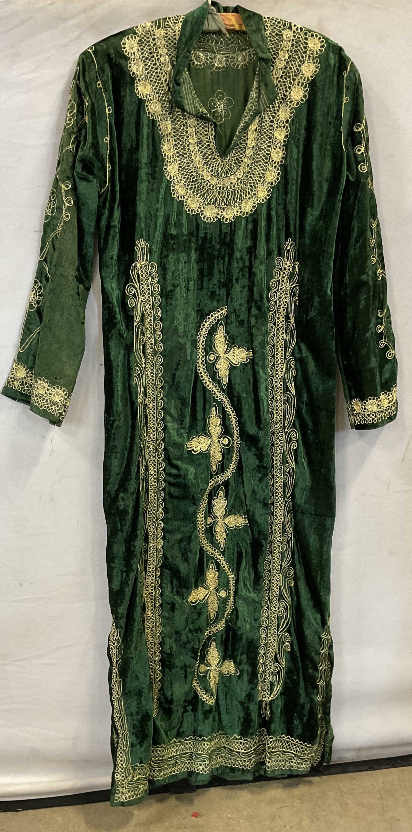 Green embroidered velvet dress: Green embroidered velvet dress. Floor length dress in size 2 with slits on the sides. Dress is long sleeve in green velvet with gold colored embroidery all over the whole dress. Middle eastern