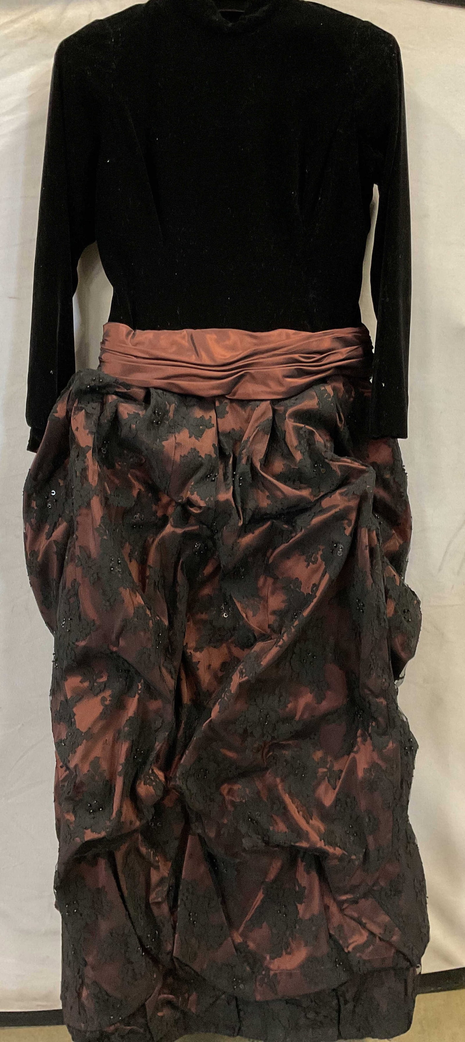 Velvet and lace long sleeved dress: Velvet and lace long sleeved dress. Bodice and sleeves are black velvet and the skirt is maroon satin like fabric with lace over top interfaced to give the skirt volume and structure. There is also