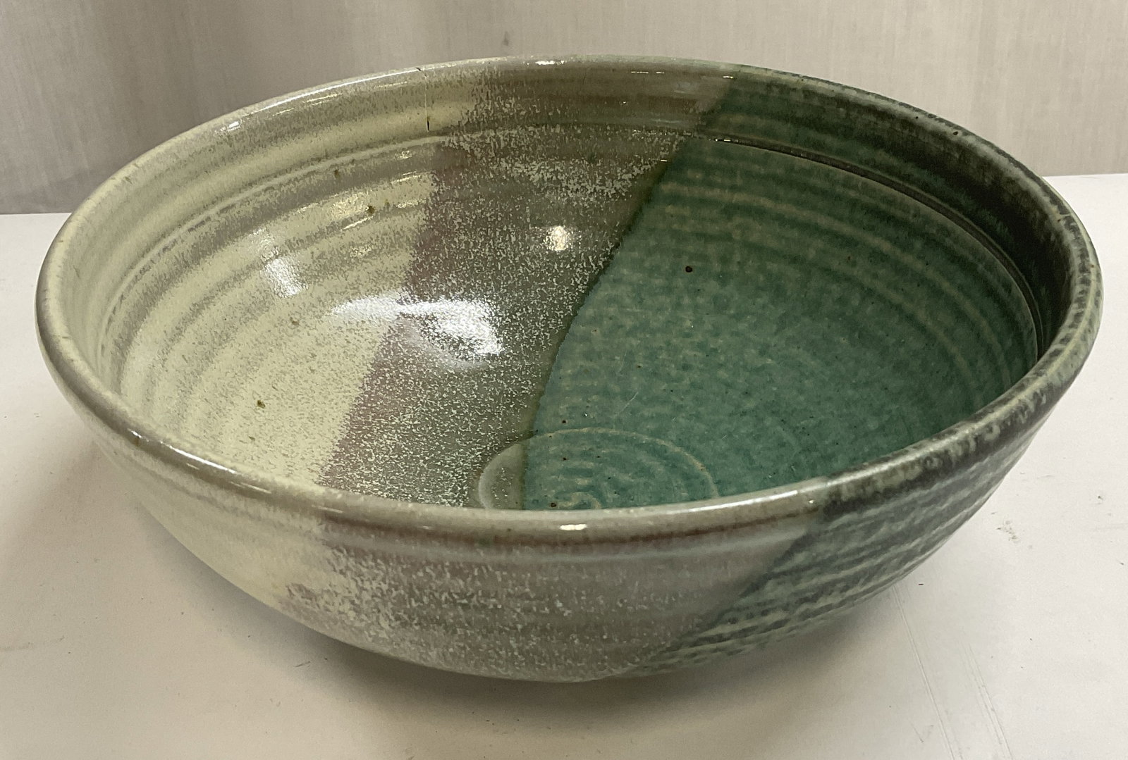1997 Blue Spruce Pottery Split-Glaze Bowl OREGON: Vintage 1997 Blue Spruce Pottery Split-Glaze Bowl. Made in Workshop in Bend, Oregon. Multi-Toned Turquoise, Sage Green, Grey, and Beige. Spiral Designs. Crack Present. Measures app 3in H x 8in Diam.