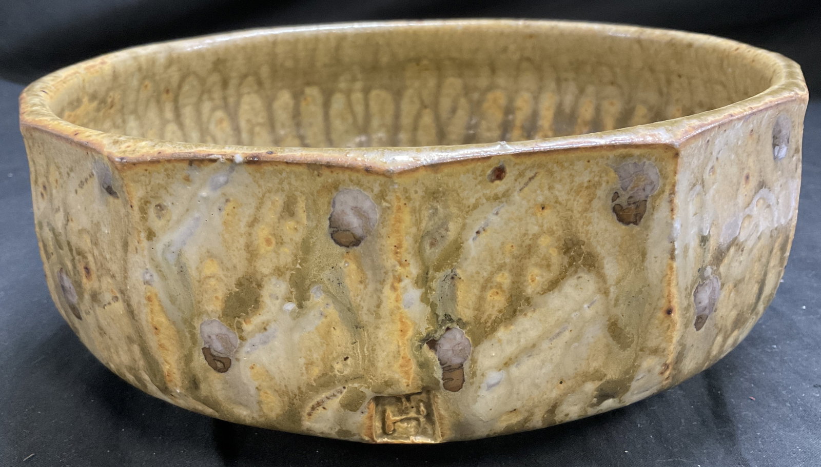 VTG SGND Hand-Thrown Studio Pottery Oct Bowl: Vintage Signed Hand-Thrown Studio Pottery Octagonal Bowl. Yellow Drip Glaze with Brown Spots and Green Swirls. Signature Reads Illegibly. Additional Seal Mark with Letters TH. Condition Consistent Wit