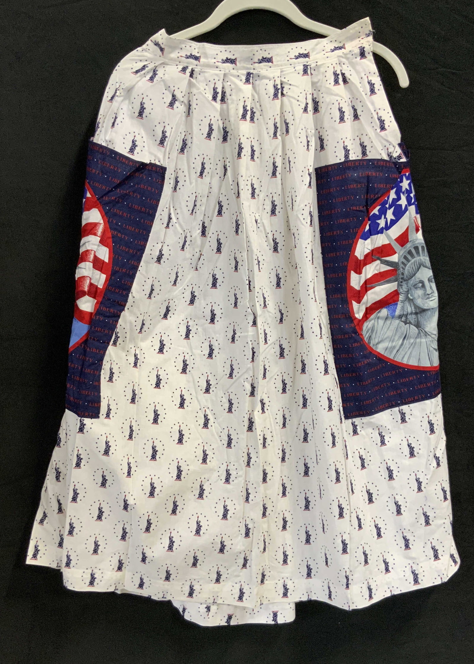 Statue of Liberty cotton Velcro skirt.: Statue of Liberty cotton Velcro closure skirt. Skirt is mid length with stature of Liberty printed all over with huge Statue of Liberty graphic pockets. Repurposed form cotton sheets the skirt has a V