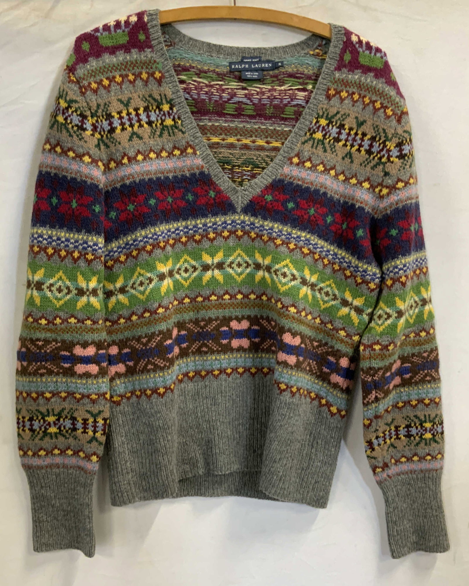 Ralph Lauren hand knit wool fair isle sweater: Ralph Lauren hand knit 100% wool fair isle sweater. Sweater features a v neck design in size XL. The neckline has some loose threads and there are some holes at the bottom front middle. Fair isle , Ra