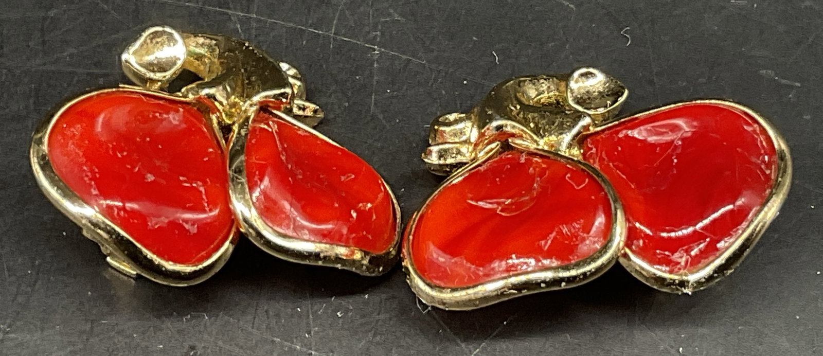 Pair VTG Trifari Double Cherry Clip-On Earrings: Pair of Vintage Circa 1980s-1990s Trifari Double Cherry Clip-On Earrings. Gold-Toned with Red Enamel. Some Corrosion. Measures app 1in L. Vintage Clip-On Earrings, 80s-90s, Trifari, Cherries, Enamel, 