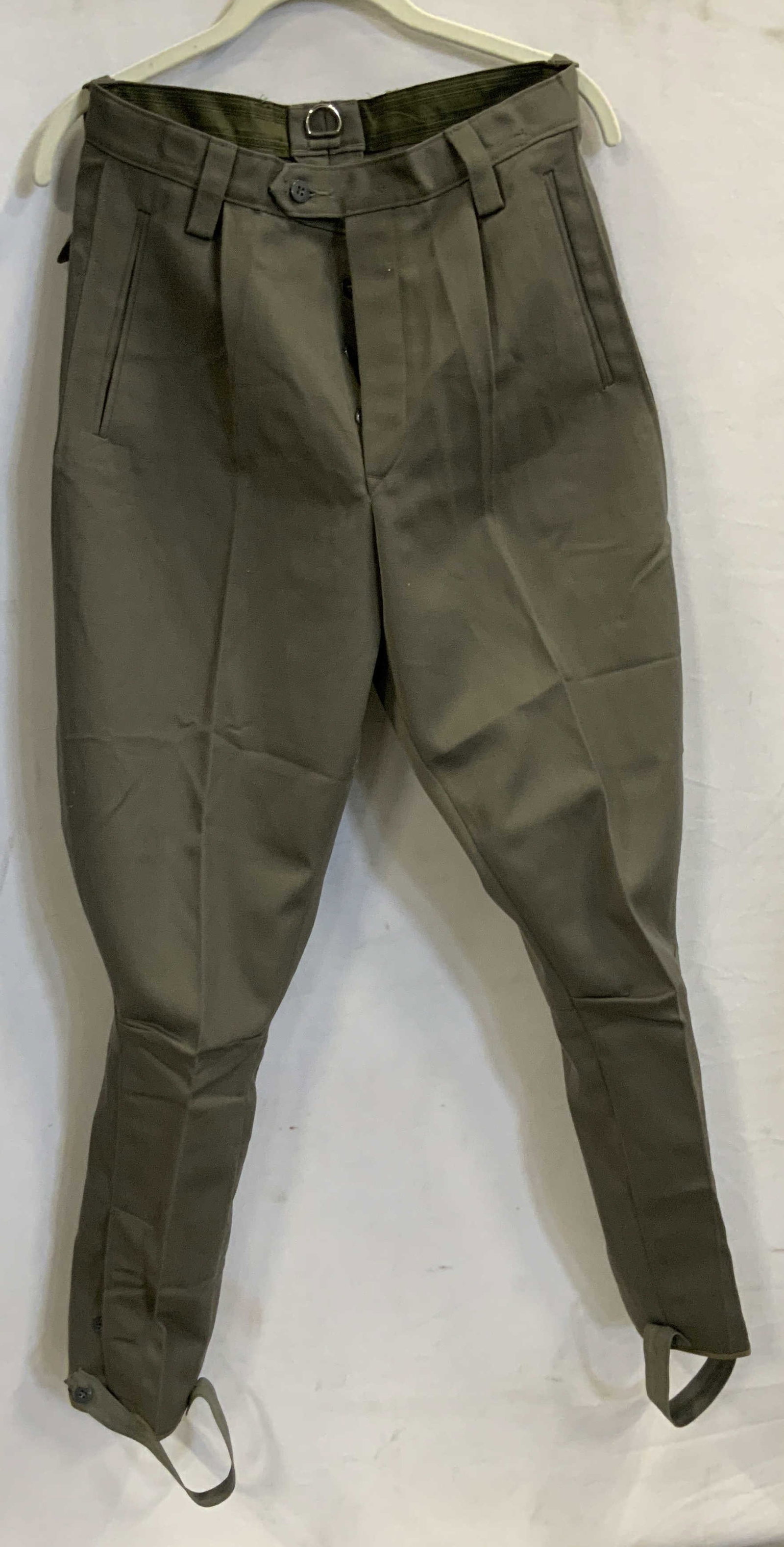 Vintage military inspired dress pants.: Vintage military inspired dress pants. Pants feature a button fly, suspender loops and foot straps. Size 44. Military inspired, suspender loops, boot straps H 11