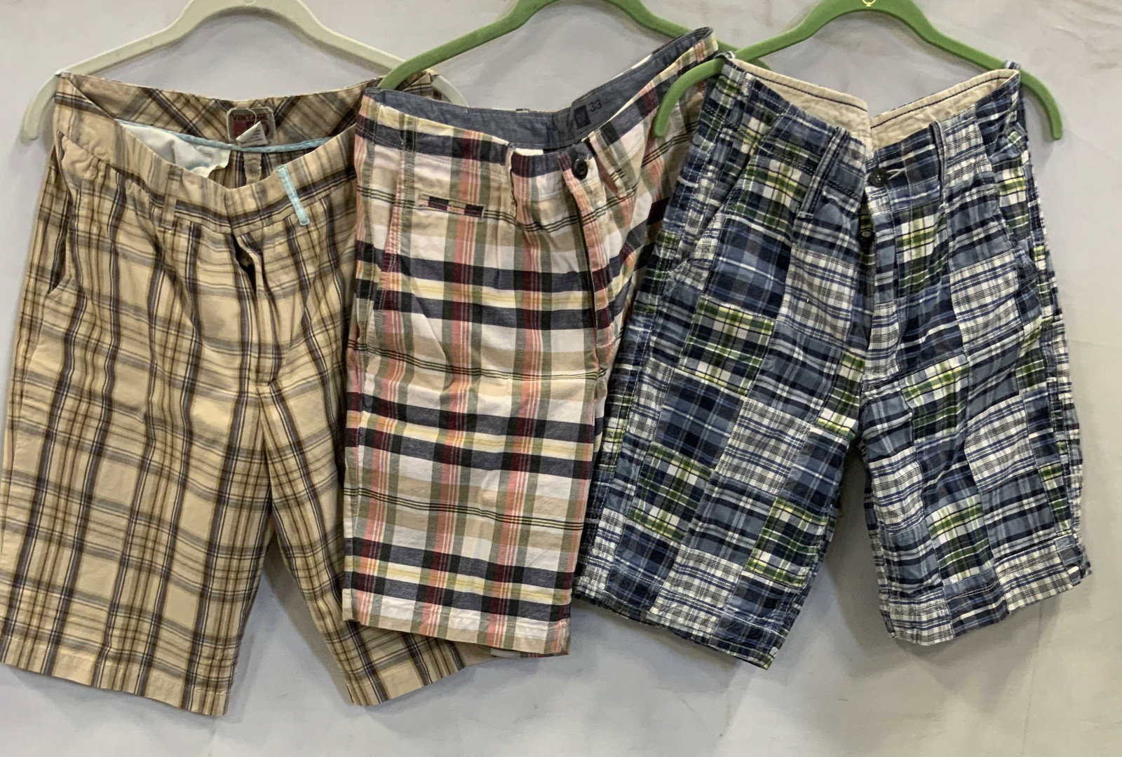 3 pairs of vintage cotton plaid shorts: 3 pairs of vintage plaid shorts. First pair Vinatge Red brown plaid shorts. Size 32 made of 100% cotton in India. Second pair Gap blue, green and red plaid size 33 made of 100% cotton. Third pair Amer