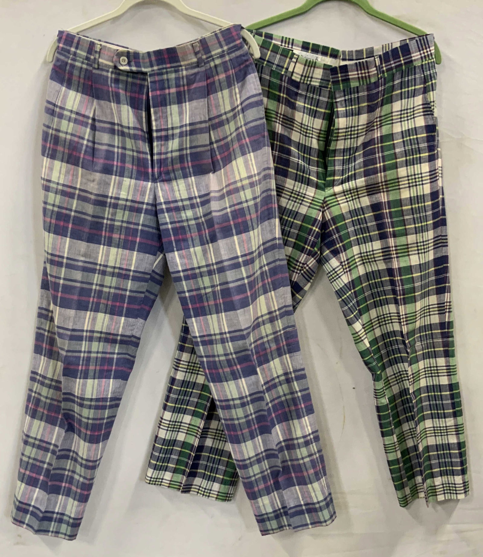 2 pairs of plaid pants 100% cotton: 2 pairs of plaid pants 100% cotton. First pair Berle hand woven purple plaid pants. No size, measures app 32in waist and app 40.5 in length and app30 in inseam Second pair, Aher green and purple plaid