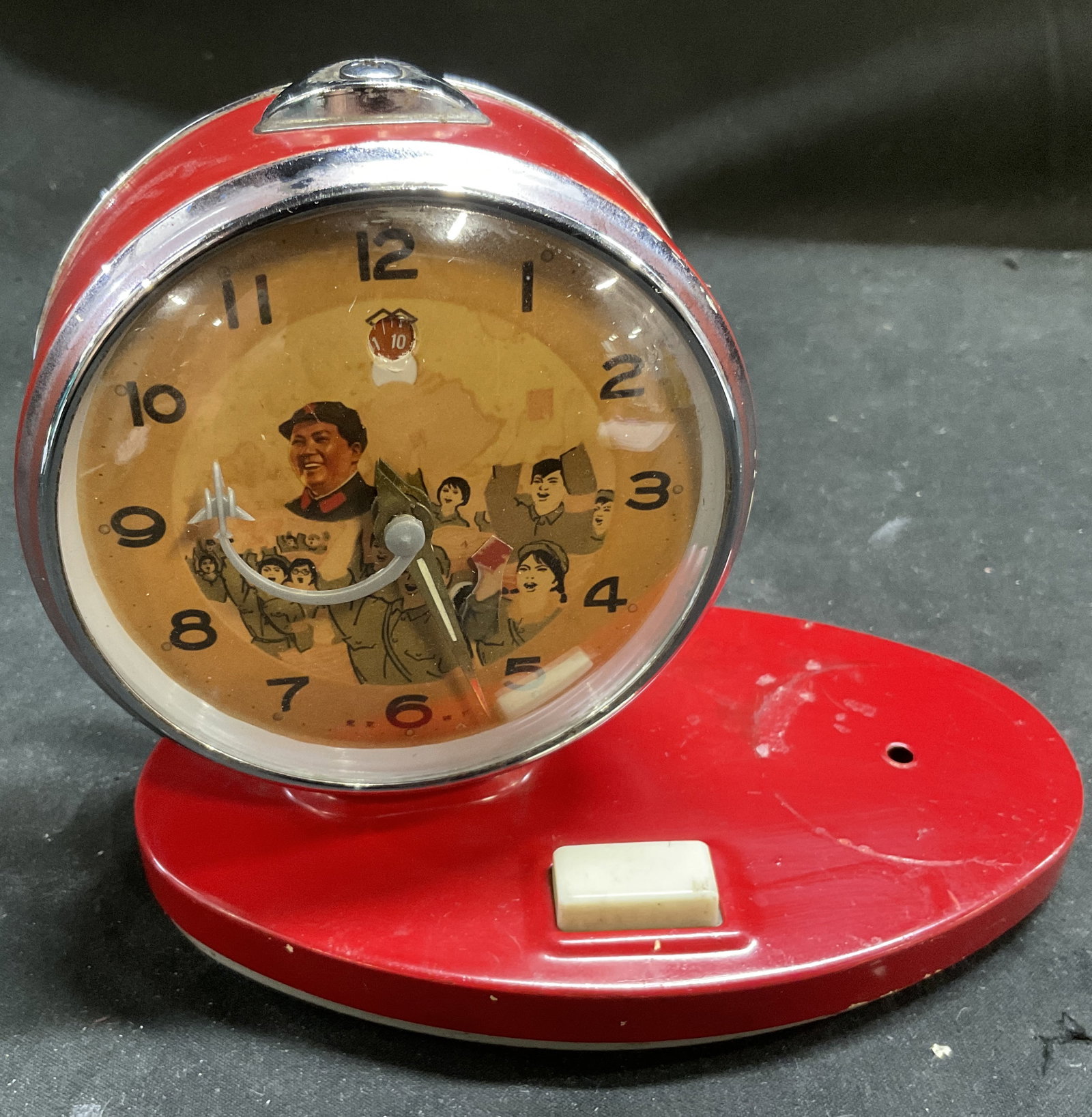 VTG Chinese Chairman Mao Propaganda Alarm Clock: Vintage Circa 1966-1976 Chinese Cultural Revolution Era Chairman Mao Animated Propaganda Alarm Clock. Red Steel Frame. Illustrations of Mao Zedong with a Crowd of Cheering Citizens Inside. Arm of Work