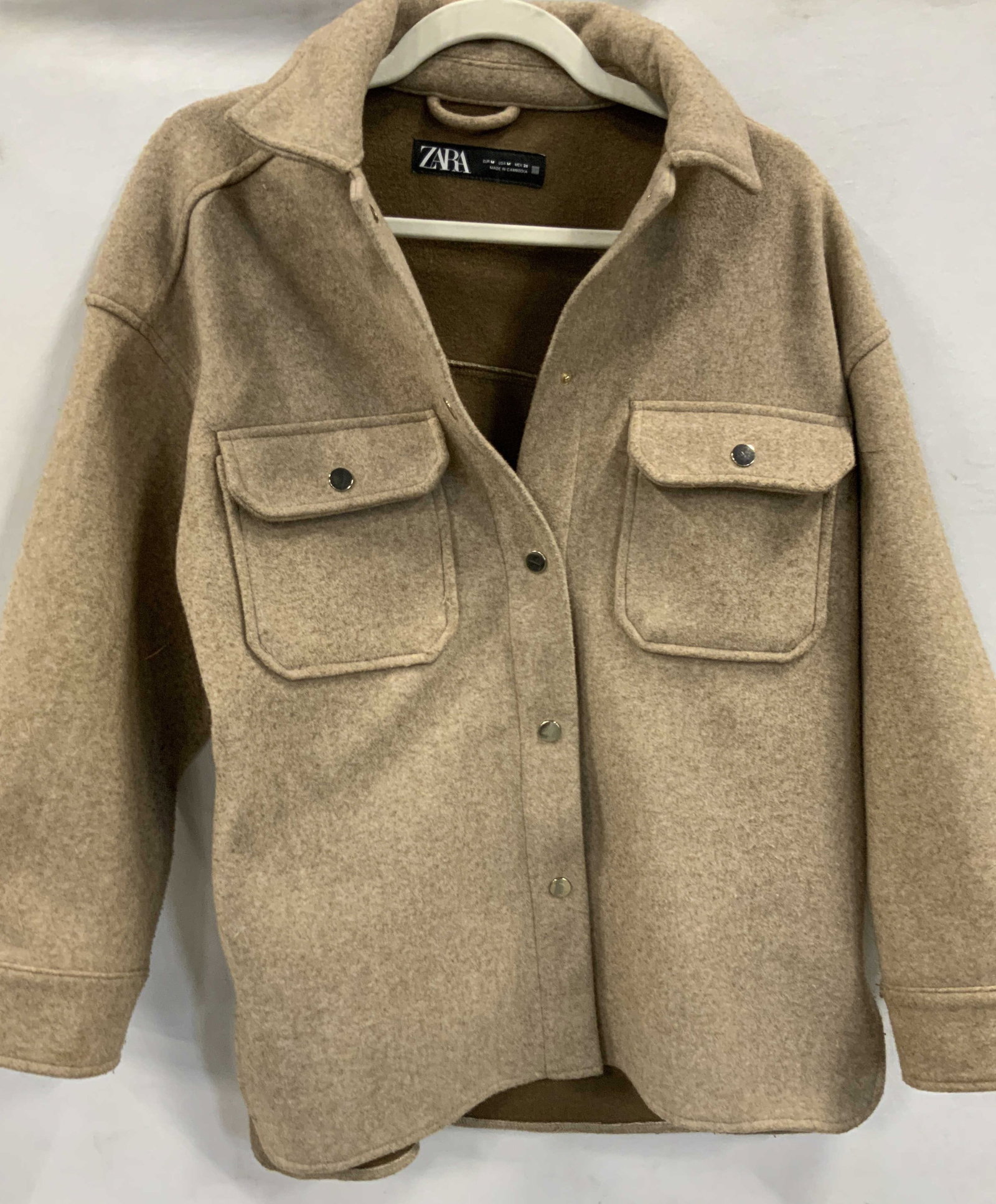 Zara faux wool coat: Zara faux wool coat. Coat is made firm100% polyester but made to look and feel like wool. Jacket features snap button closure, latch chest pockets and snap cuff sleeves. Size medium. Faux wool, snaps 