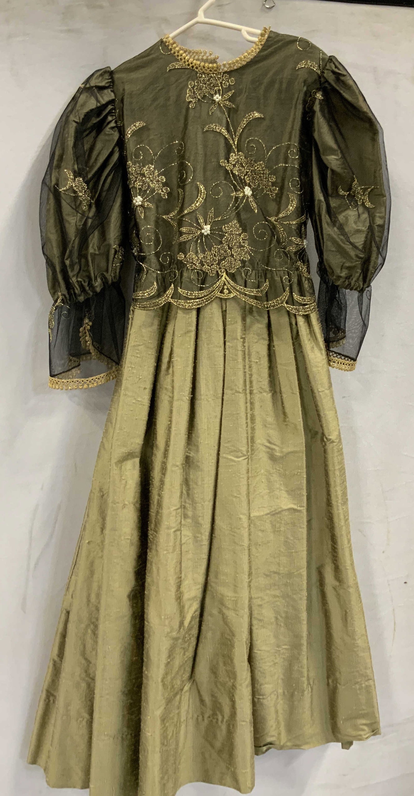 Posies hand crafted raw silk dress: Posies hand crafted raw silk dress. Dress is made of 100% silk with a mesh and beaded bodice over top of the silk. Dress I short sleeves and mid length. Pearl button closure and ribbon tie in the back