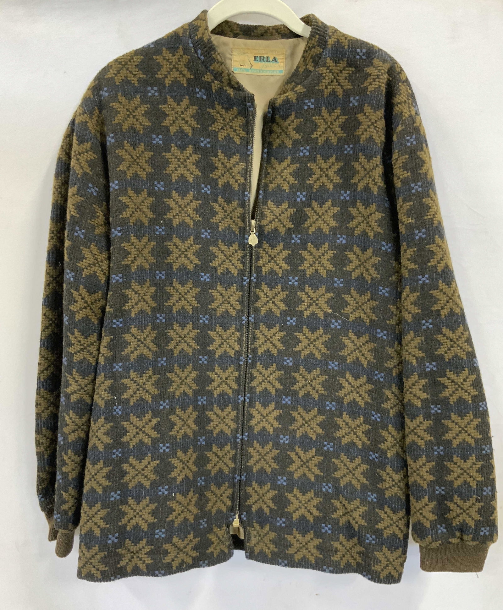 Erla woven jacket. Scandinavian wool made Sweden: Erla woven jacket. 100% Scandinavian wool. Made in Sweden. Wool material in brown black and blue. Features a lined interior and zipper closure. 2 zipper front pockets and one interior pocket. Zipper p