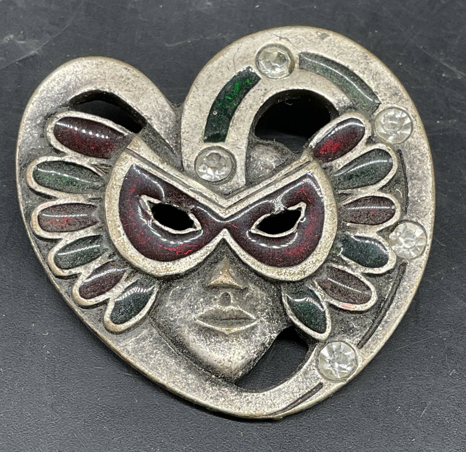 Vntg Venetian Style Carnival Mask Brooch: Silver toned Venetian mask brooch featuring colorful enamel accents and rhinestone details, measures app diameter 2 inches, estate jewelry