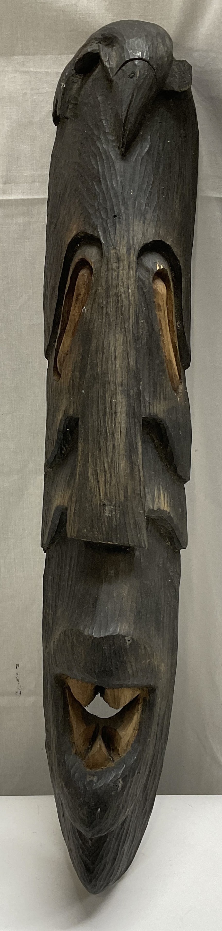 VTG SGND Hand-Carved African Sty Wall Mask 22in: Vintage Signed Hand-Carved African Tribal Style Wall Mask. Signed CH ST FL IX. Long Dense Hardwood with Multiple Carved Facial Expressions Stacked Vertically. Fish at the Top. Open Hollowed-Out Mouth 