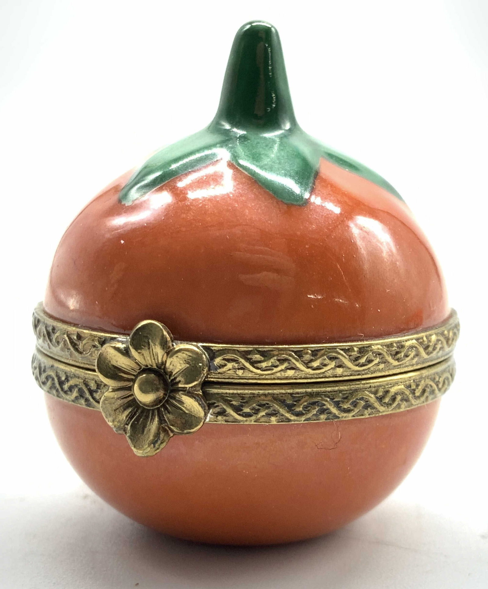 Limoges France Porcelain Tomato Pill Box: Limoges France tomato Firm pill box red with green stem brass hinges and rims, inside reads hand painted Limoges France , Jacques 58/500, limited edition, measures app 1.25 inches round, smalls