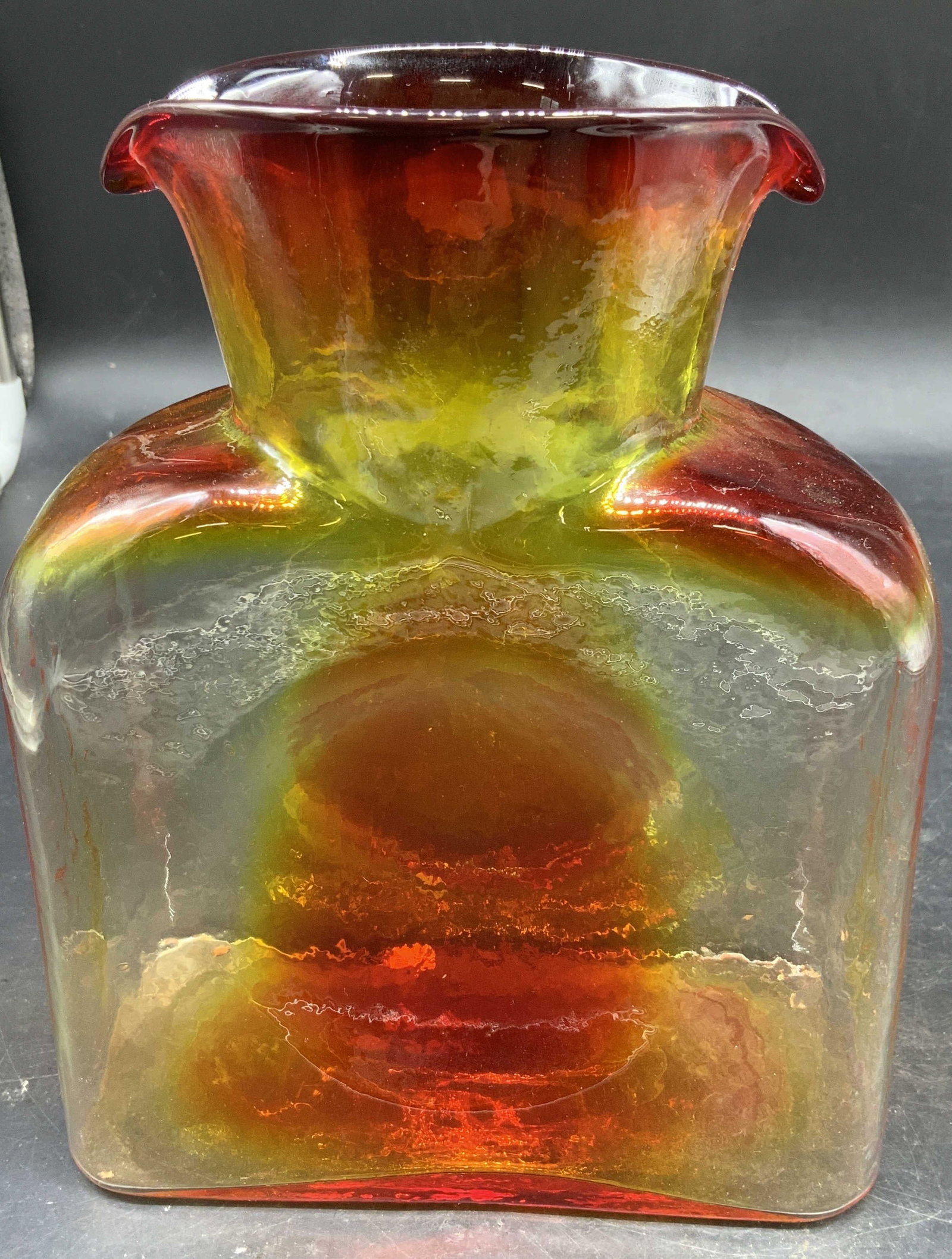 BLENKO Art Glass Water Bottle, USA: Vintage BLENKO Art Glass Water Bottle in the iconic double spout design, features an Amberina color way blending shades of red and yellow app HT 8 inches, base app 6.5 by 3 inches, collectible art gla