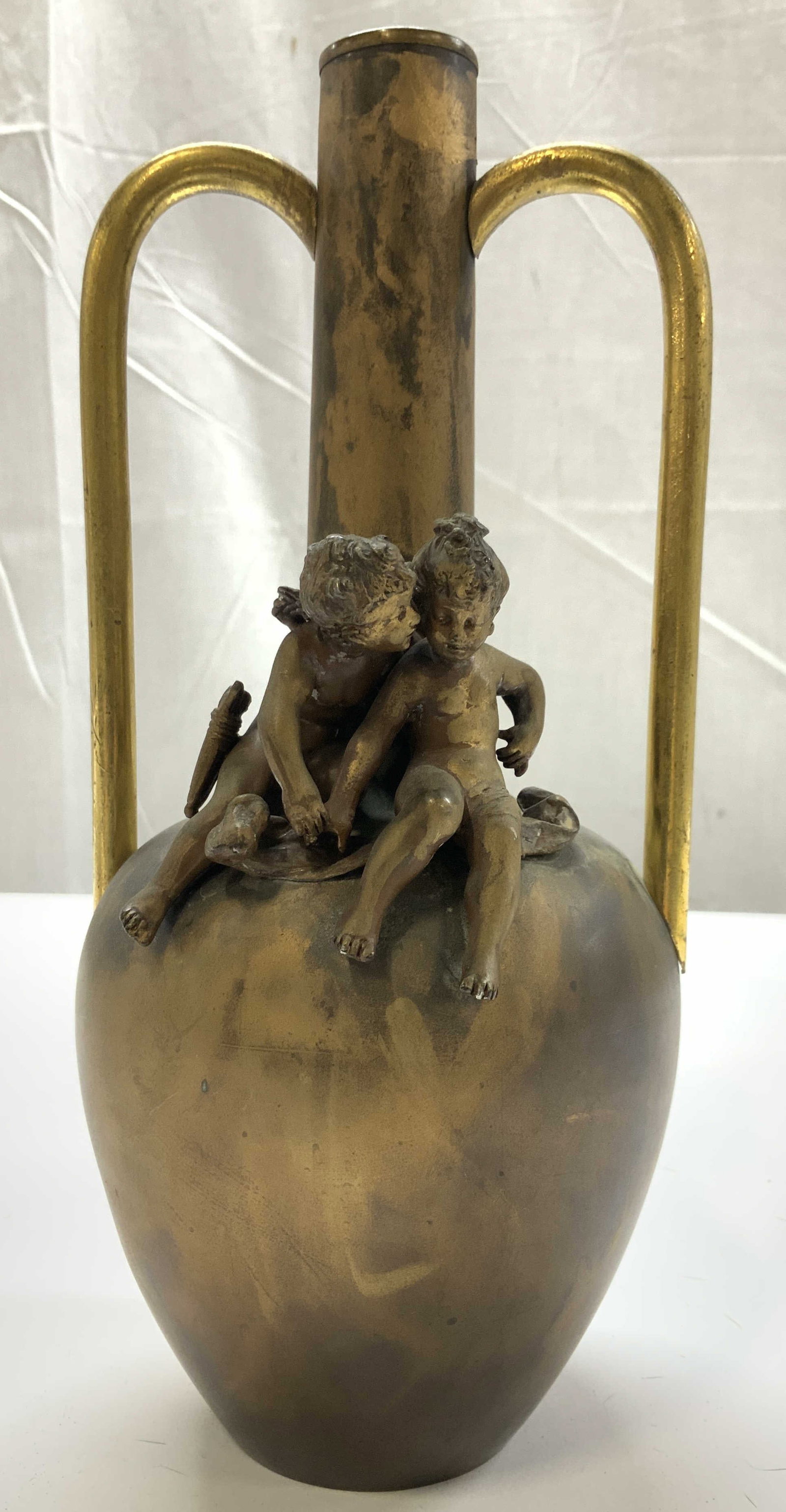 Antq Gilt Bronze Vase w Putti Figurals: Antique Gilt Bronze Vase with tall narrow neck, double elongated handles and winged puttis seated Figurals , art nouveau figural vase from late 19th century, ht app 10.5 inches, width app 5 inches