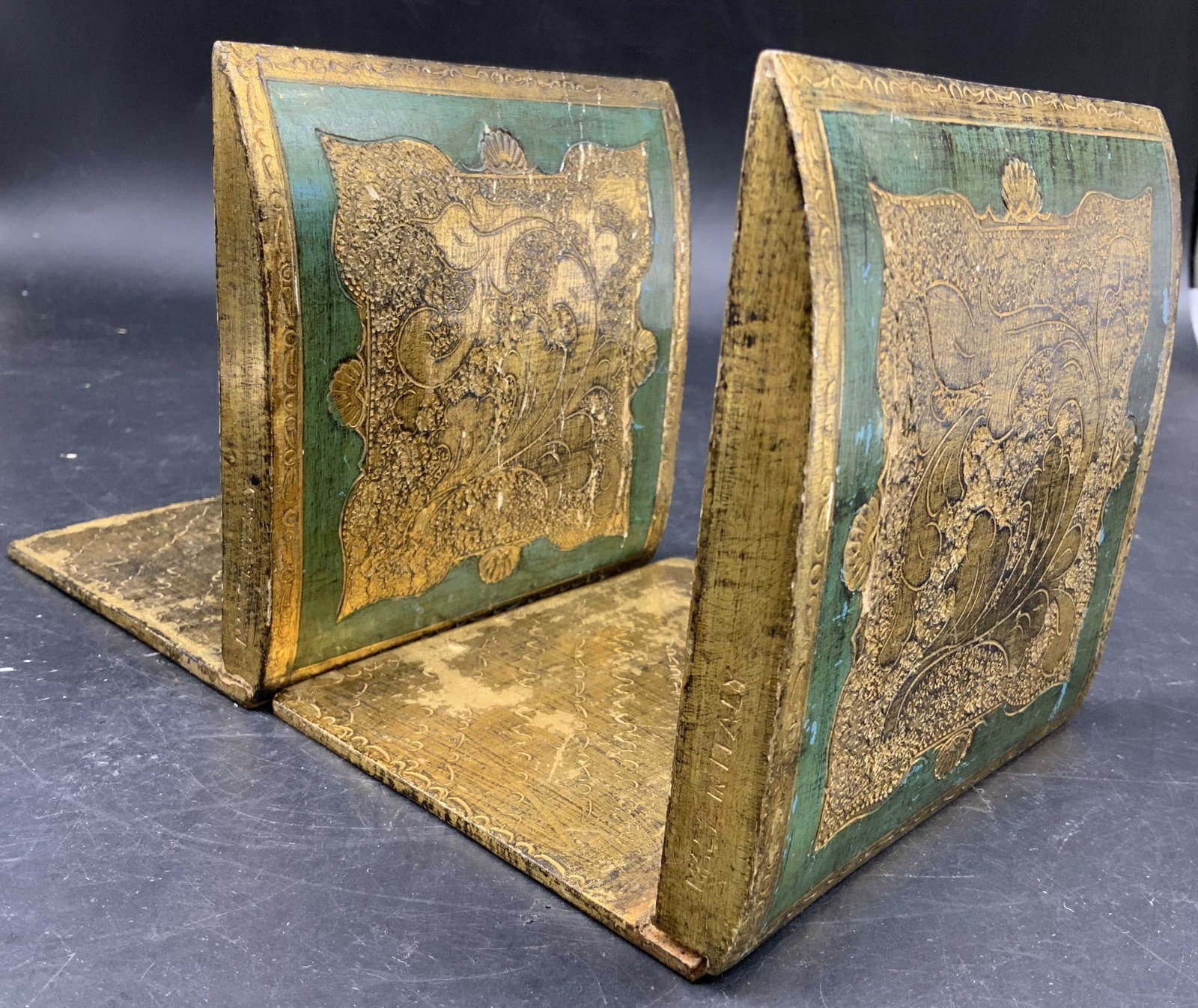 Pr Vntg Italian Florentine Gilt Wood Book ends: Pair of vintage Italian Florentine Book ends featuring a detailed green and gold leaf Giltwood design, wood base, circa 1950-1960, some wear consistent w age and use, each measures ht app 5 inches wid