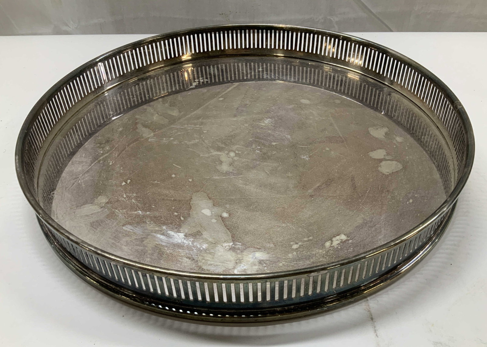 Vntg Silver Plate Circular Gallery Tray 14 in: Vintage circular silver plate gallery tray measures diameter 14 inches ht app 1.5 inches, with distinctive pierced gallery railing and a polished mirrored surface