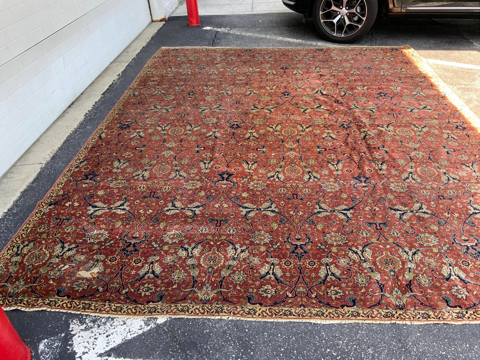 Antique SAROUK Rug with deep Red Field: Antique SAROUK Wool Rug, characterized by its deep red field adorned with intricate floral motifs and a detailed border, measures 135 inches by 160 inches, room size wool rug