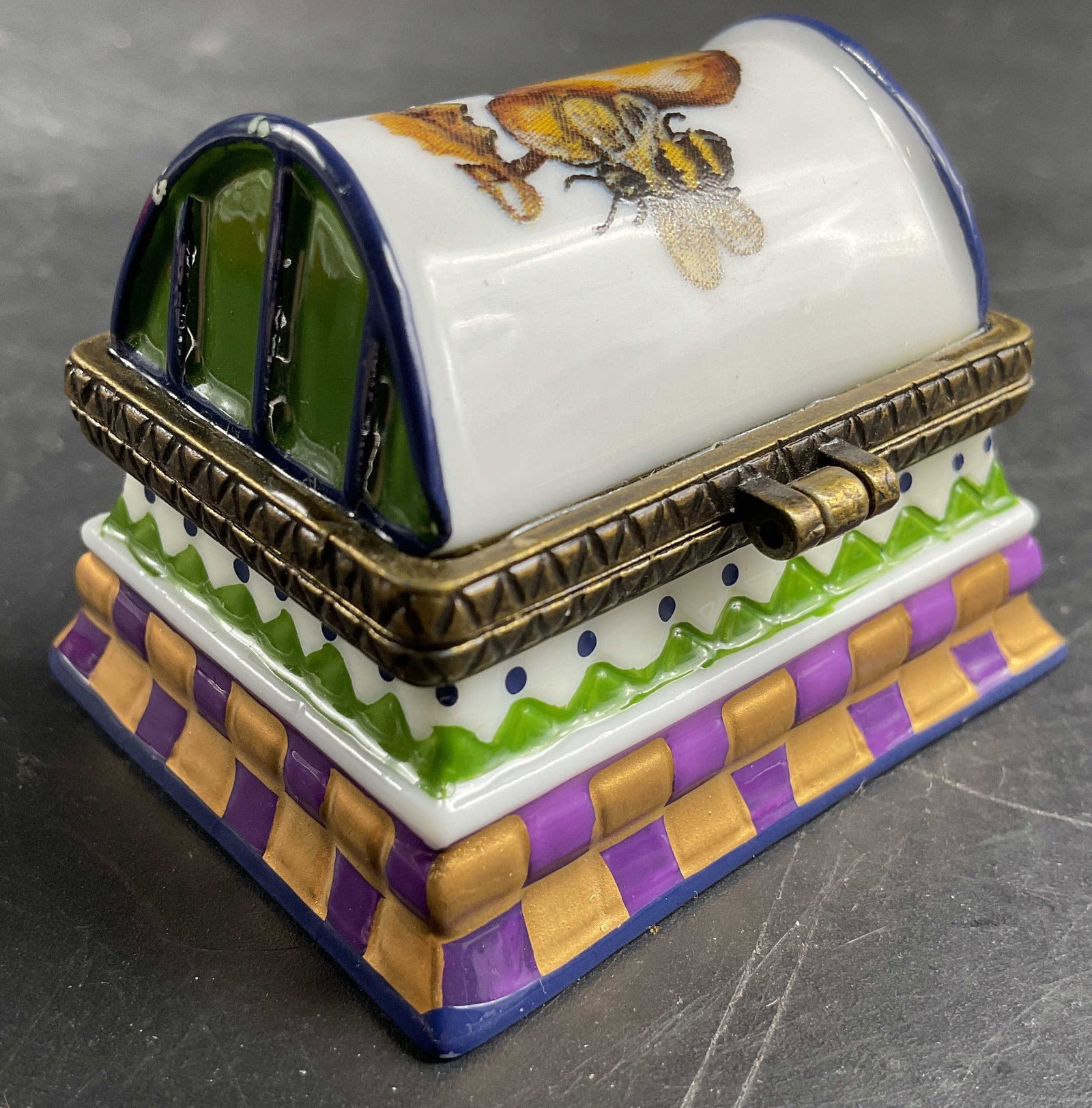 1997 Tracy Porter Porc Pill Box: Tracy Porter 1997 colorful porcelain pill box, brass hinged lid, geometric motifs with bumble bee and pear on domed lid, measures app hat 1.75 inches, base 2 by 1.5 inches, smalls
