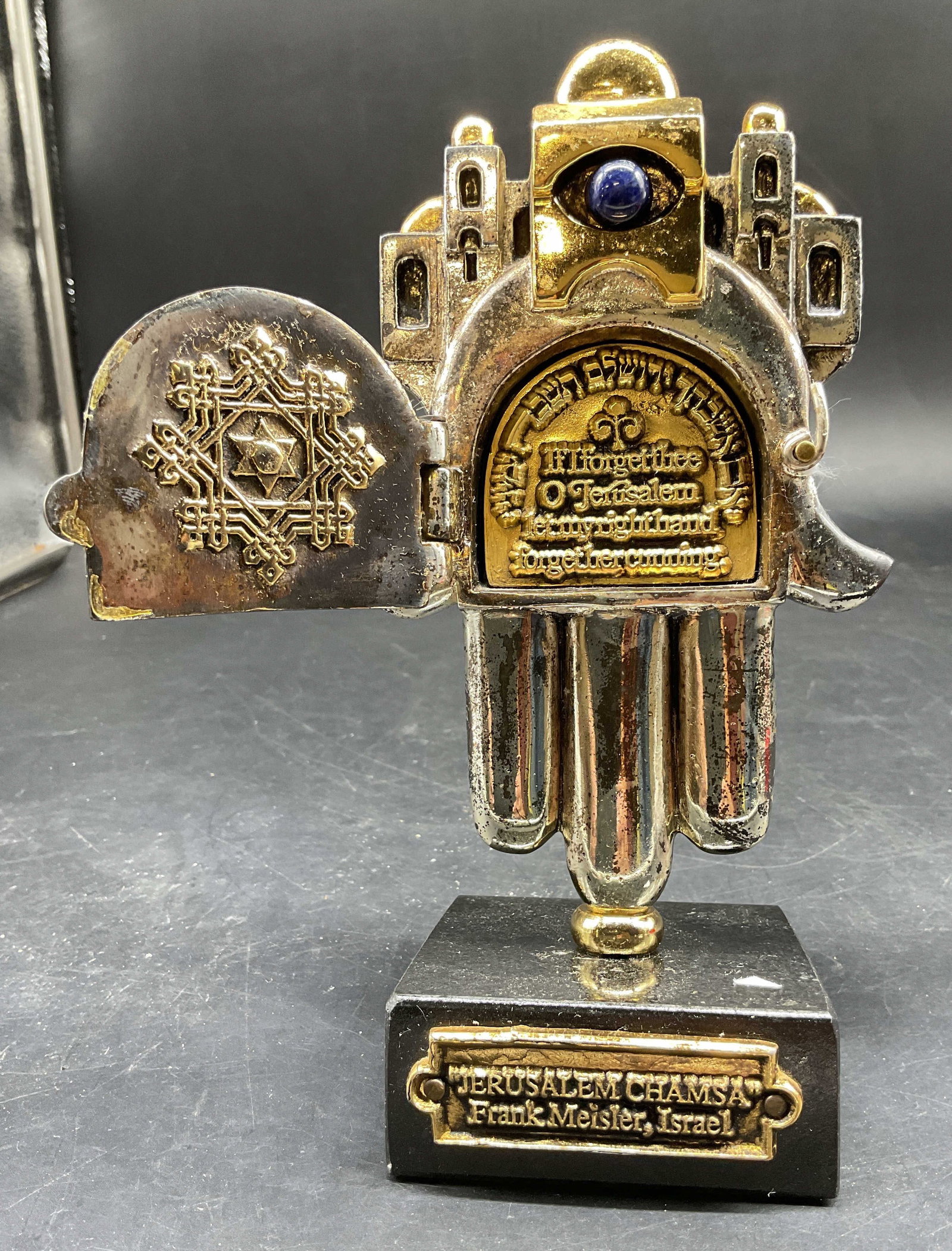 Frank Meisler Hamsa Sculpture Israel: Silver and gold plated Jerusalem Hamsa Sculpture by Israeli artist Frank Meisler, features a lapis lazuli stone set in the center, with the cityscape of Jerusalem depicted on top, the sculpture includ