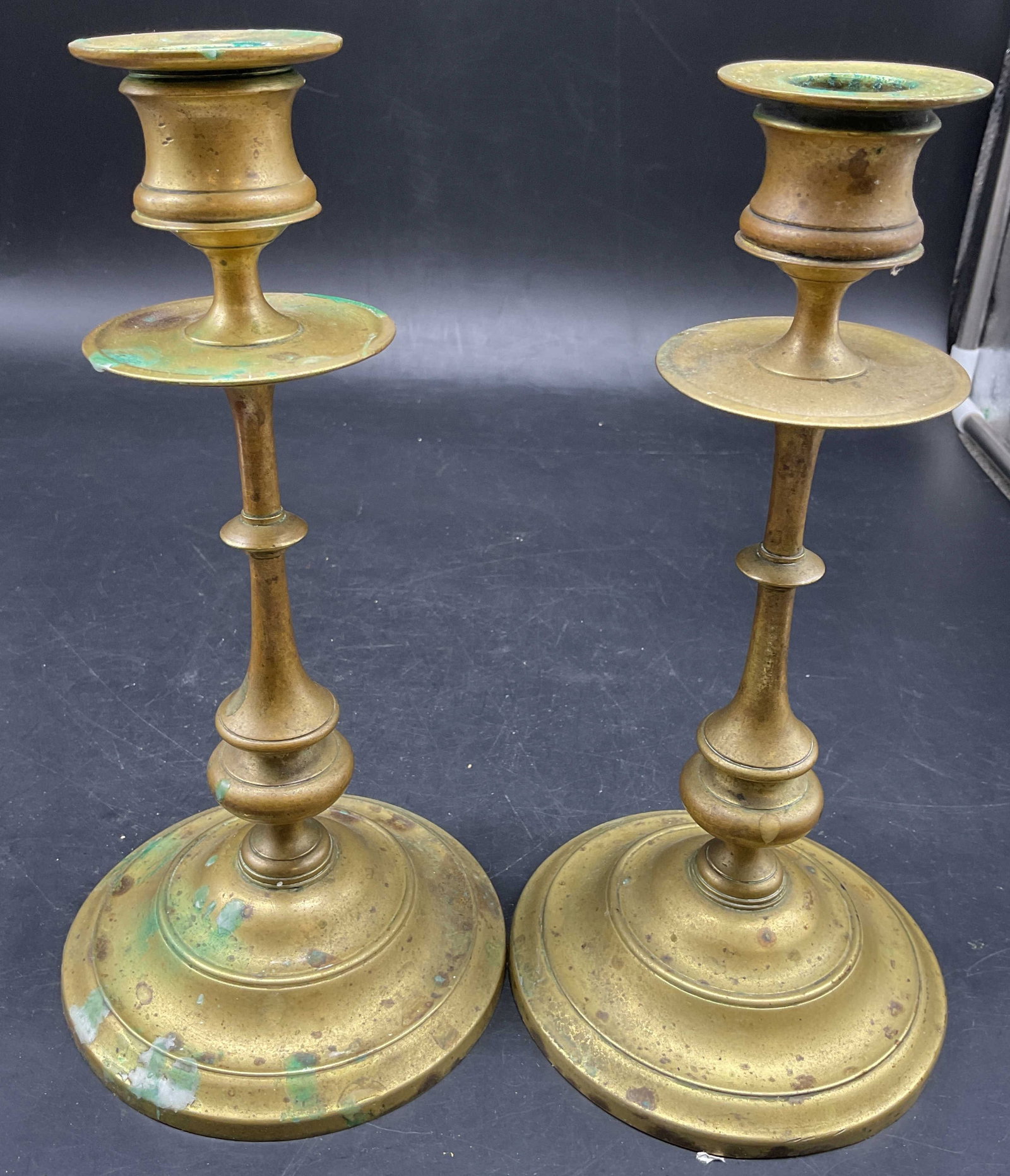 Pr Antique Heemskerk Brass Candlesticks: Antique brass candlesticks featuring a central drip pan and a turned stem, Heemskerk , Netherlands, , European candlesticks, each measures ht app 9 inches, base diameter app 475 inches, pieces have