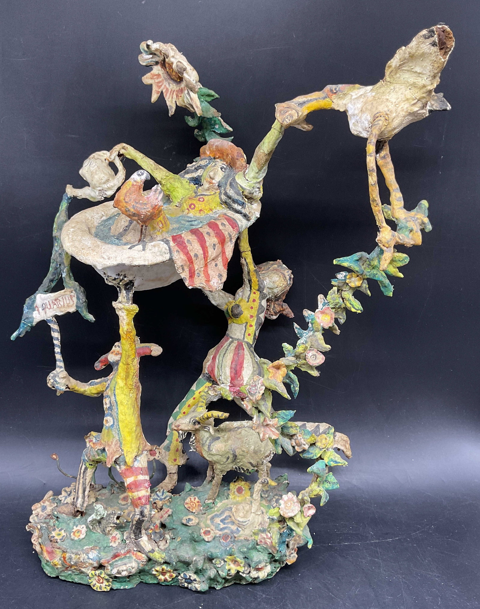 William Stevens Papier-Mache Circus Act Sculpture: Whimsical sculpture attributed to American Artist William Stevens , papier mache circa 1980 , brightly colored and costumed figures, with florals, birds, goat, bathtub signs clown and more stacked in