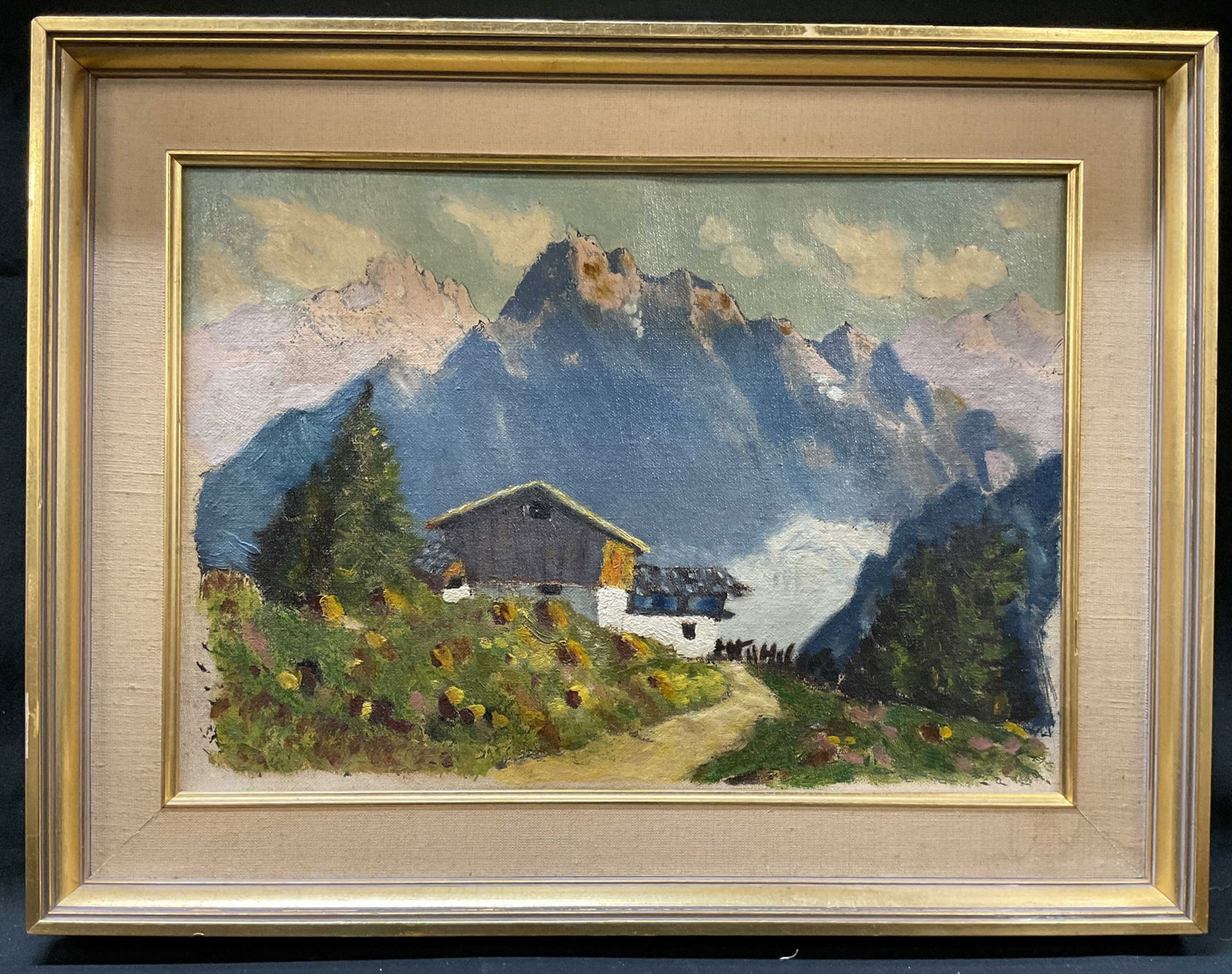 Vintage Oil painting Mountain Cabin on Canvas: Vintage oil painting on canvas depicting a mountain cabin landscape, style consistent with mid 20th century European Alpine landscapes featuring a chalet style cabin against a rugged mountain back