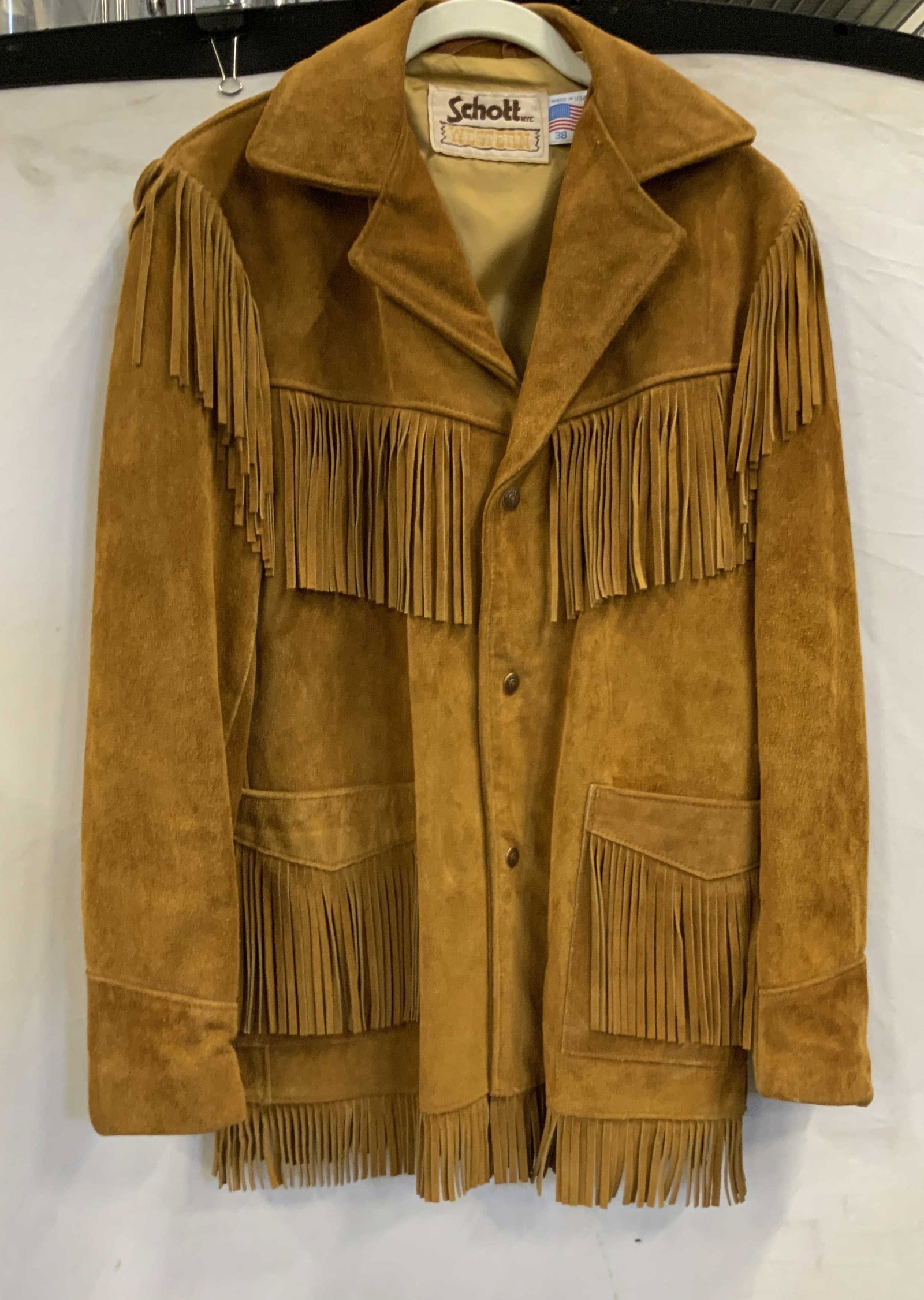 Schoot Western suede leather fringe jacket USA: Schoot Western suede leather fringe jacket. Made in the USA. Jacket features a snap closure and 2 front pockets. Lots fringe detail, on the pockets, down the arms, across the chest and around the