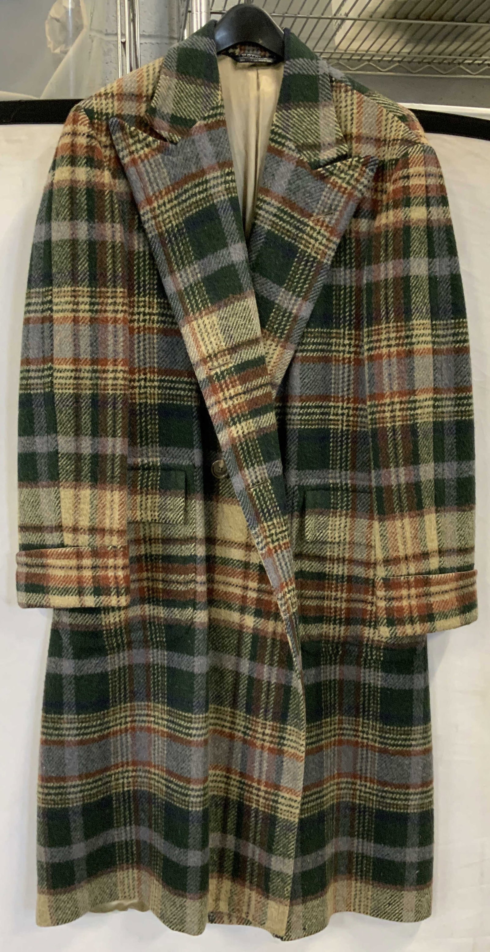 Polo, Ralph Lauren wool plaid coat USA: Polo, Ralph Lauren wool plaid coat. Made in the USA. Green blue and red plaid wool lined with silk coat. Button closure. No size listed. Measures app 21 in across chest and app 49 in length. Small hol