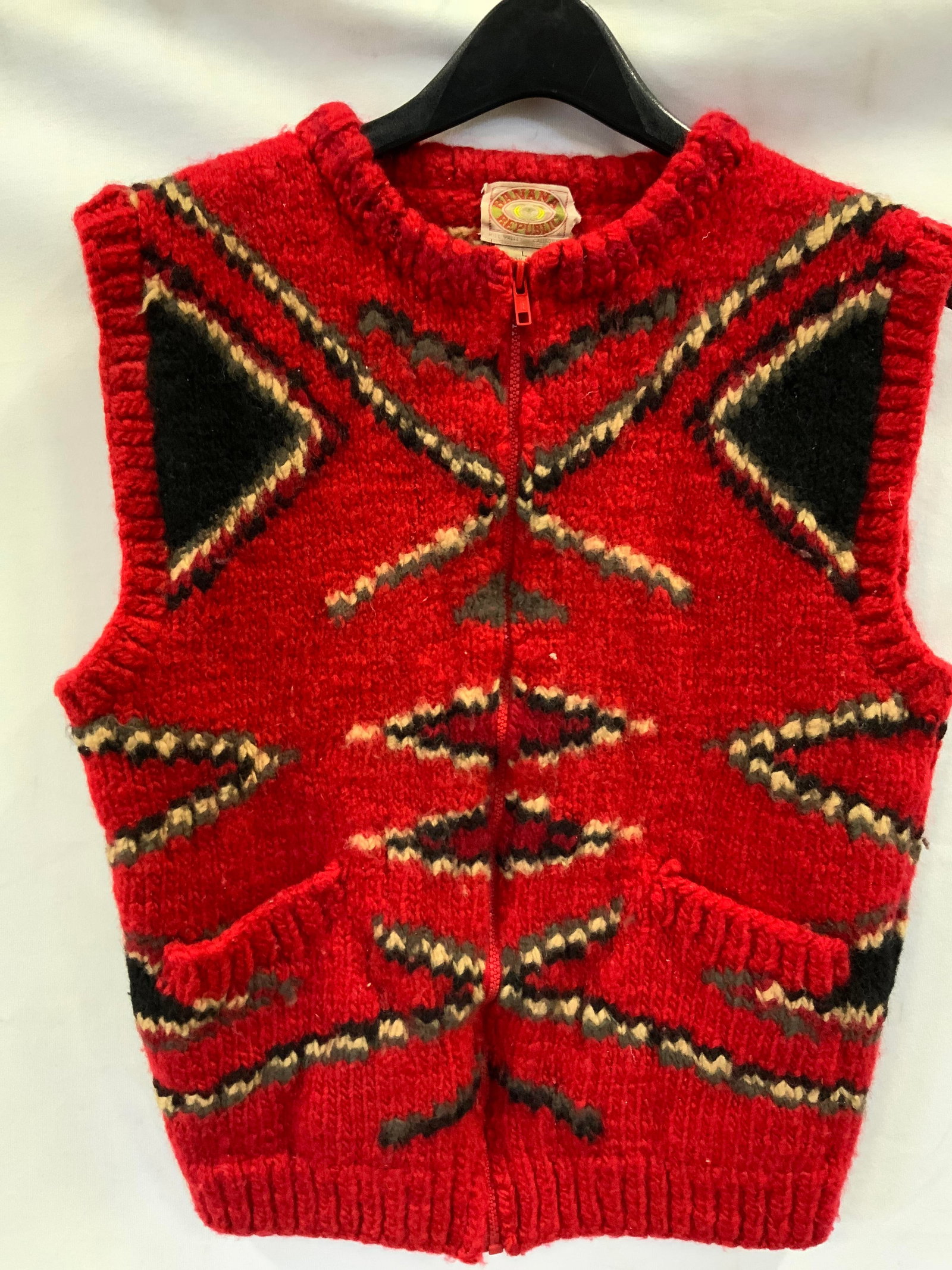 Vintg Banana Republic hand knit wool sweater vest: Vintage Banana Republic hand knit sweater vest. Made of 100% hand knitted wool. Features a zipper closure, 2 front pockets in a red and black geometric design. Vintage, Banana Republic, sweater vest,