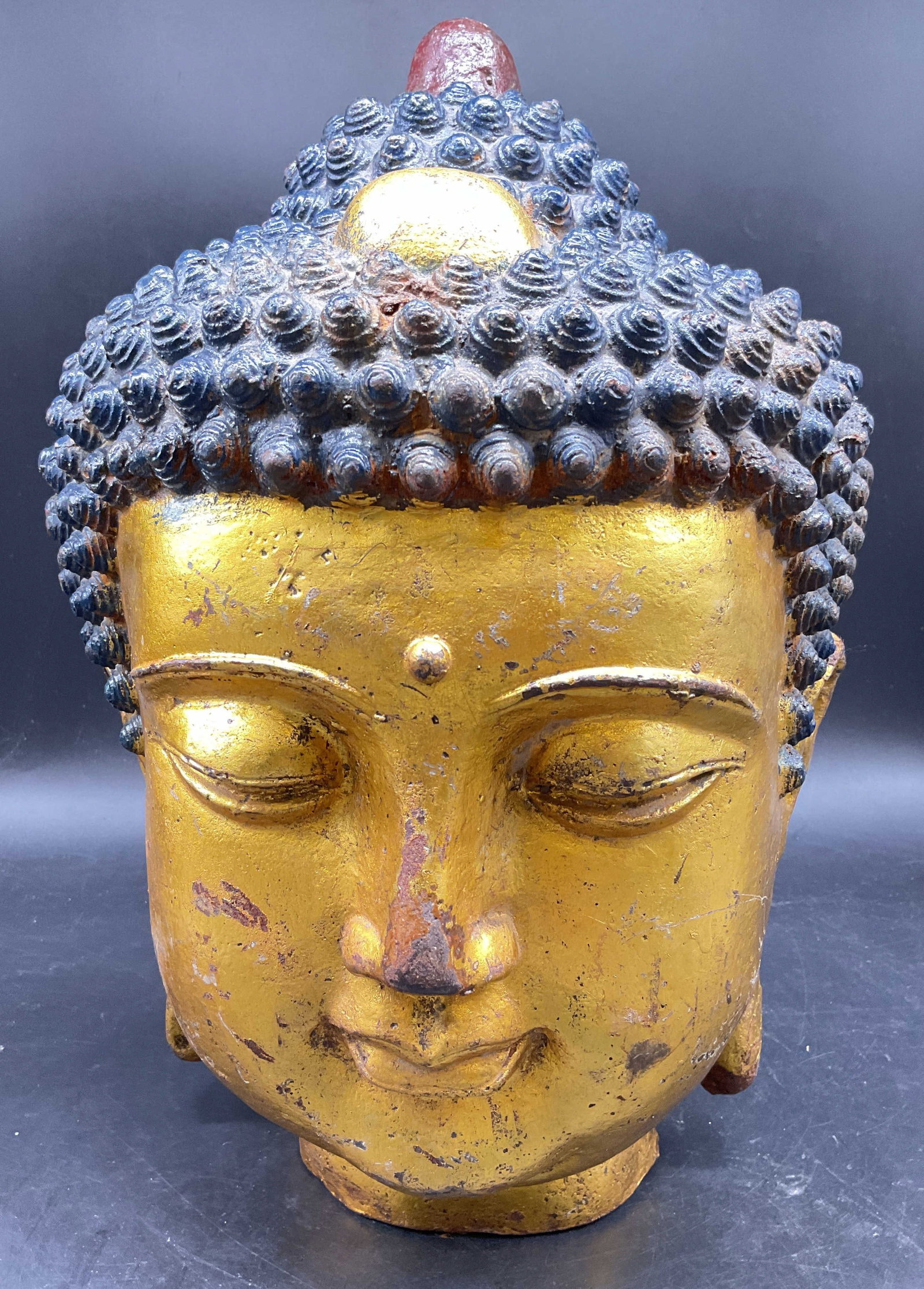 Gilded Patinated Bronze Buddha Head 15 in: Gilded Patinated Bronze Buddha Head Sculpture, vintage, statue features the classic Ushnisha Top Knot and curly hair with a distinctive gold finish and aging marks, piece has weight, the facial featur