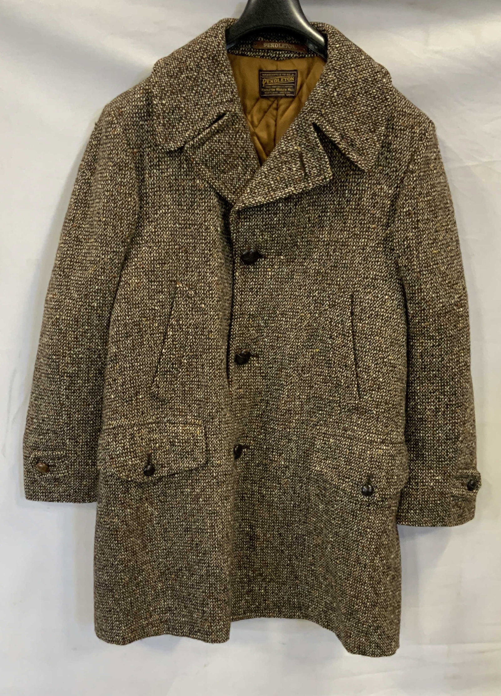 Pendelton tweed wool coat: Pendelton tweed wool coat. Features big brown buttons for closure, pockets and sleeve cuffs. Quilted lining not attached at bottom. Tweed, Pendelton, wool H 11