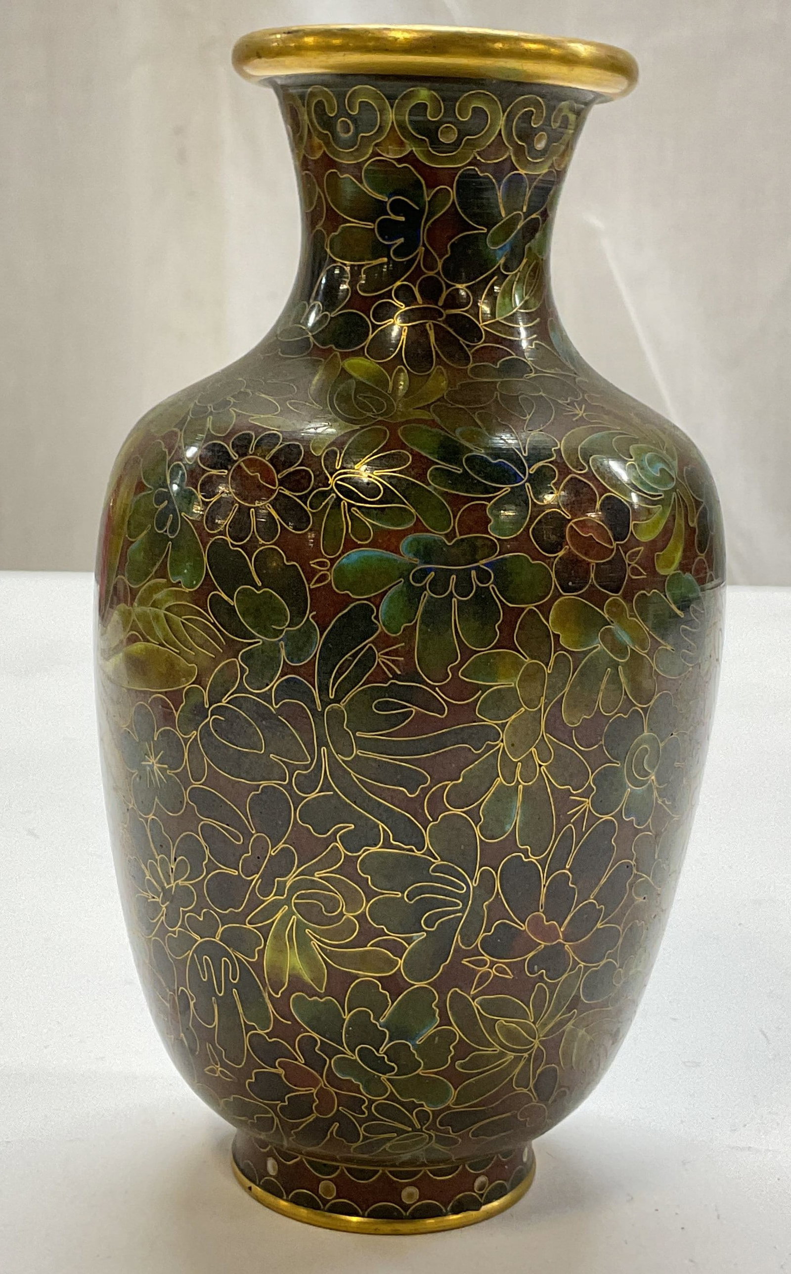 Vintage Chinese Cloisonne Enameled Vase: Vintage Chinese cloisonne enameled vase. Enameled brass. Gilt rim and accents. Floral motifs in varying colors. Bulbous body and narrow neck with flared rim. Footed base. Measures ht approx 6 inches d