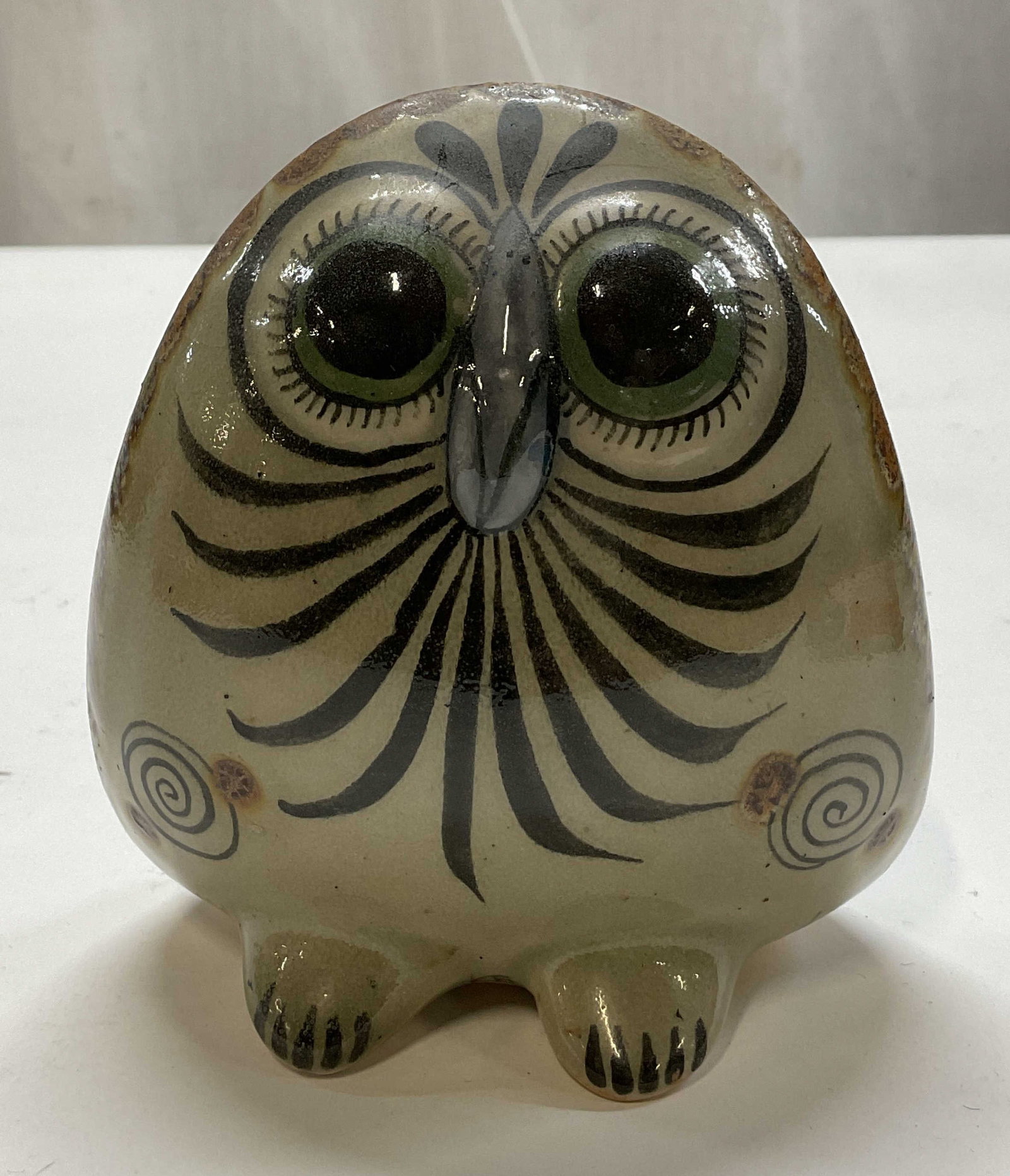 SGND Ken Edwards Ceramic Owl Figure Mexico: Signed Ken Edwards handcrafted ceramic owl figure. Signed Mexico KE. Signature large round eyes. Hand painted feathered line accents. Varying colors. Bird and floral motifs on backside. Glossy finish.