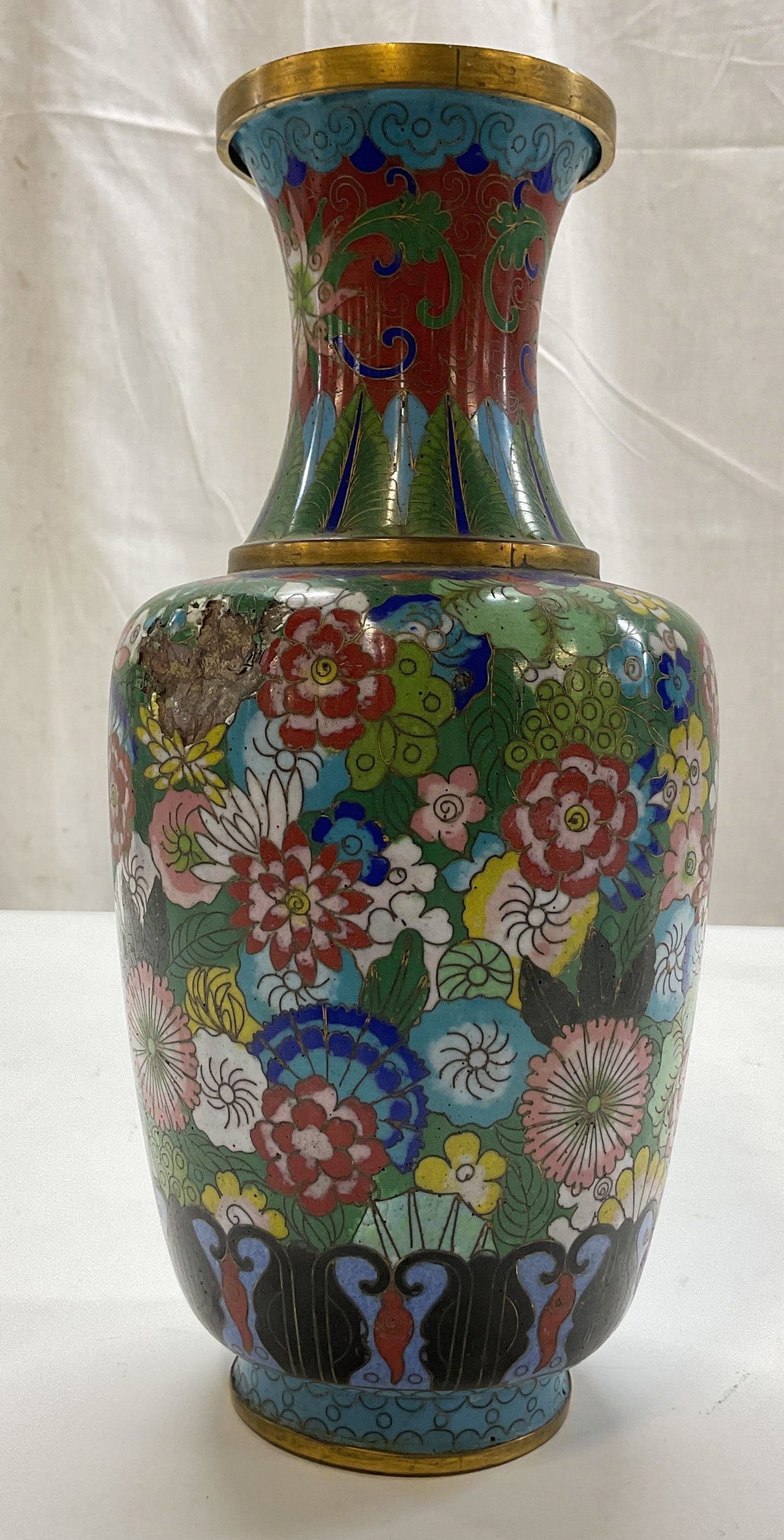 Vintage Chinese Cloisonne Enameled Vase: Vintage Chinese cloisonne enameled vase. Enameled brass. Gilt rim and accents. Floral motifs in varying colors. Bulbous body and narrow neck with flared rim. Footed base. Measures ht approx 10 inches 