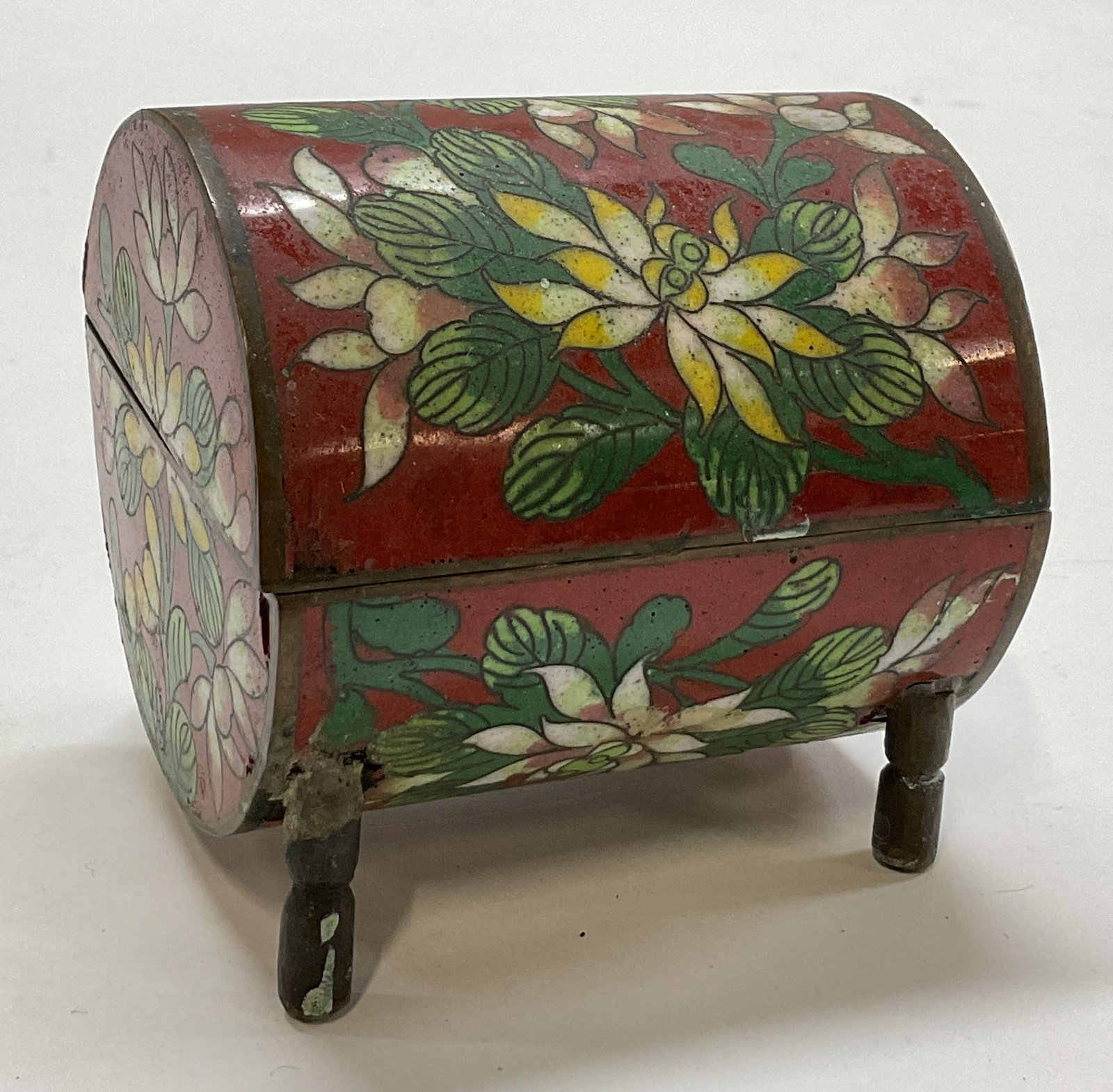 Vintage Chinese Cloisonne Footed Trinket Box: Vintage Chinese cloisonne enameled footed hinged trinket box. Shaped like a trunk. Hinged lid. Four feet on underside. Enameled brass. Floral motifs in varying colors with gilt accents. Measures appro